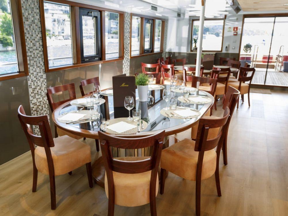 a table with chairs and tables aboard QUEEN ELEGANZA Yacht for Charter