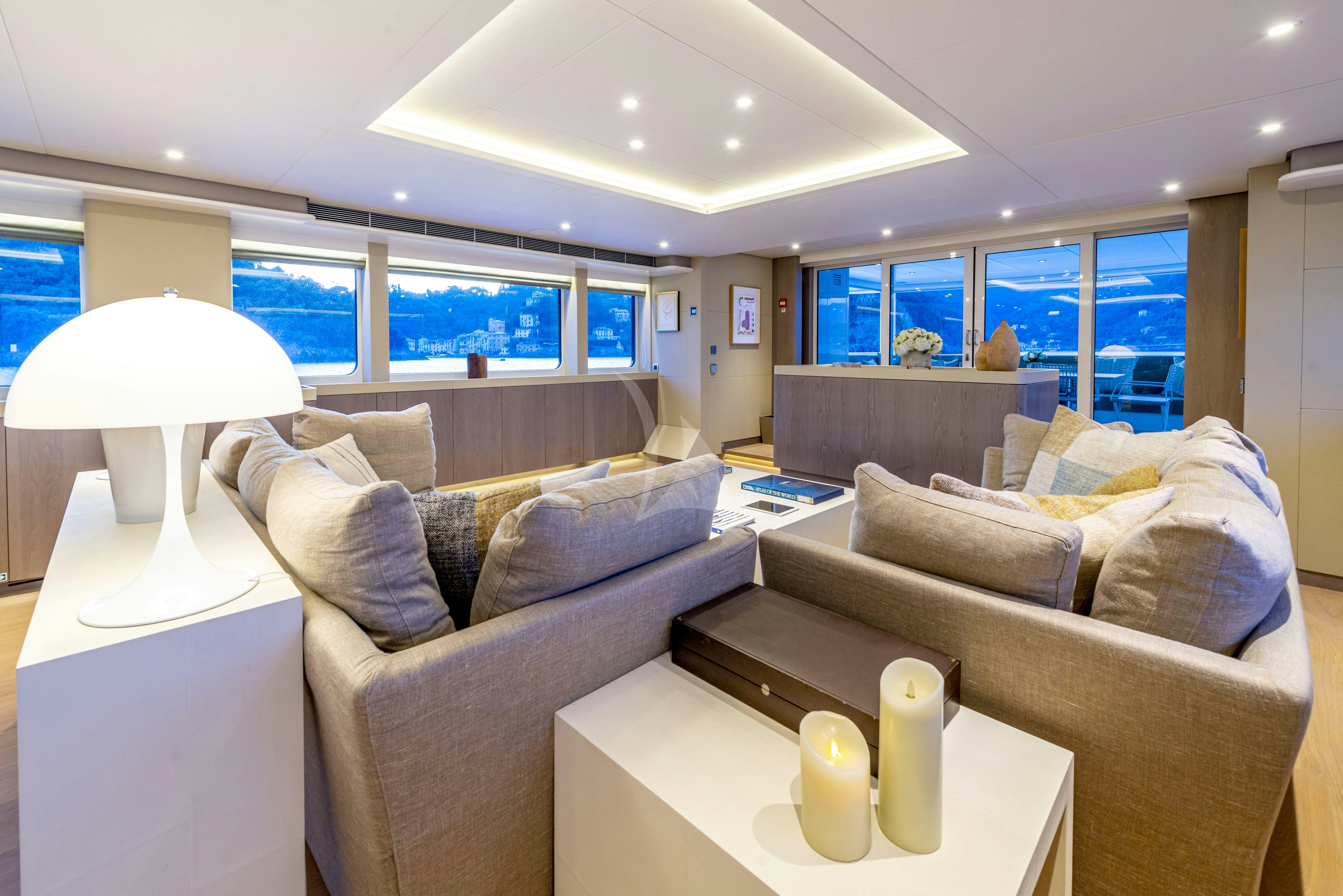 a living room with a couch and a table aboard UNEXPECTED Yacht for Charter
