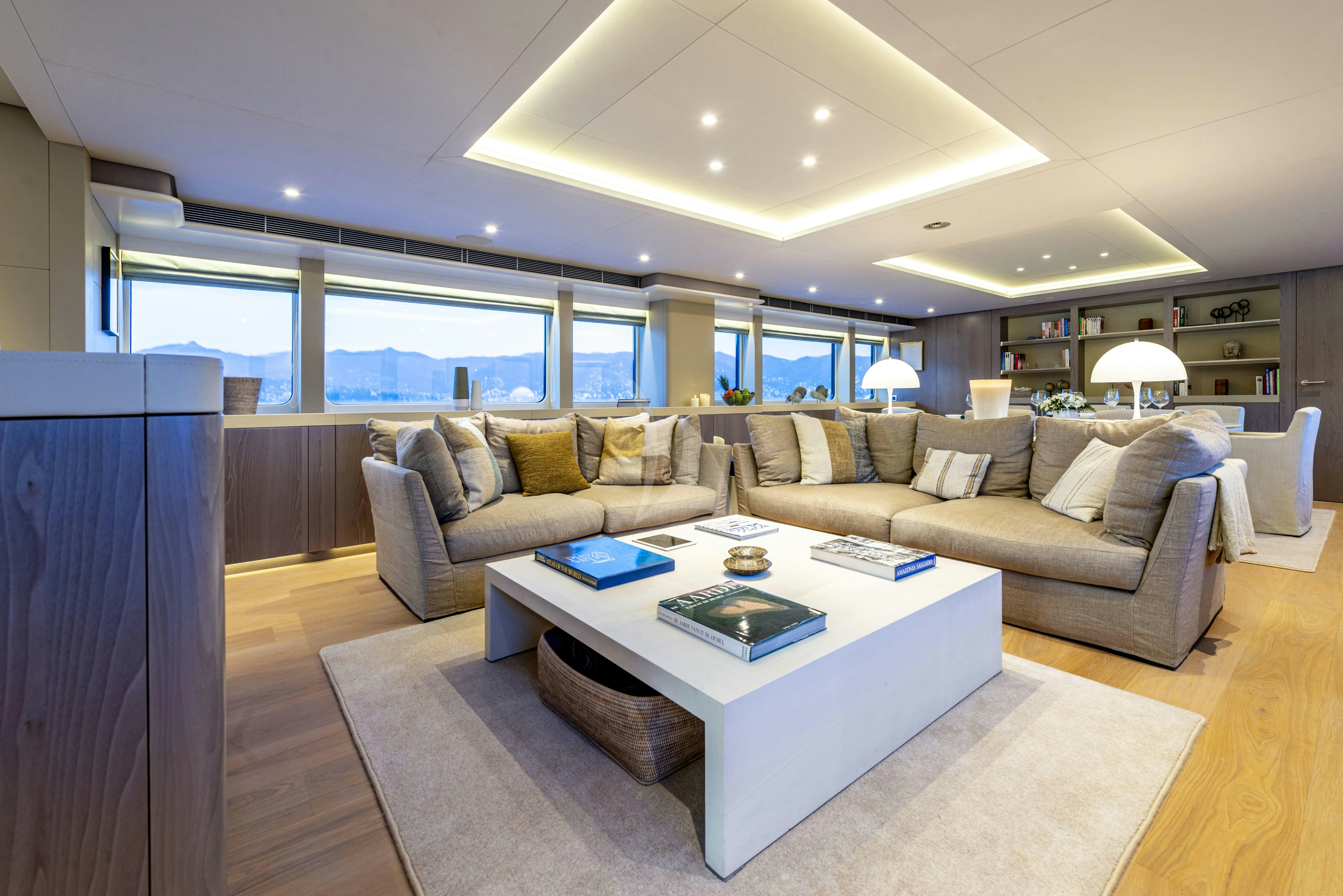 a living room with a couch and a table aboard UNEXPECTED Yacht for Charter