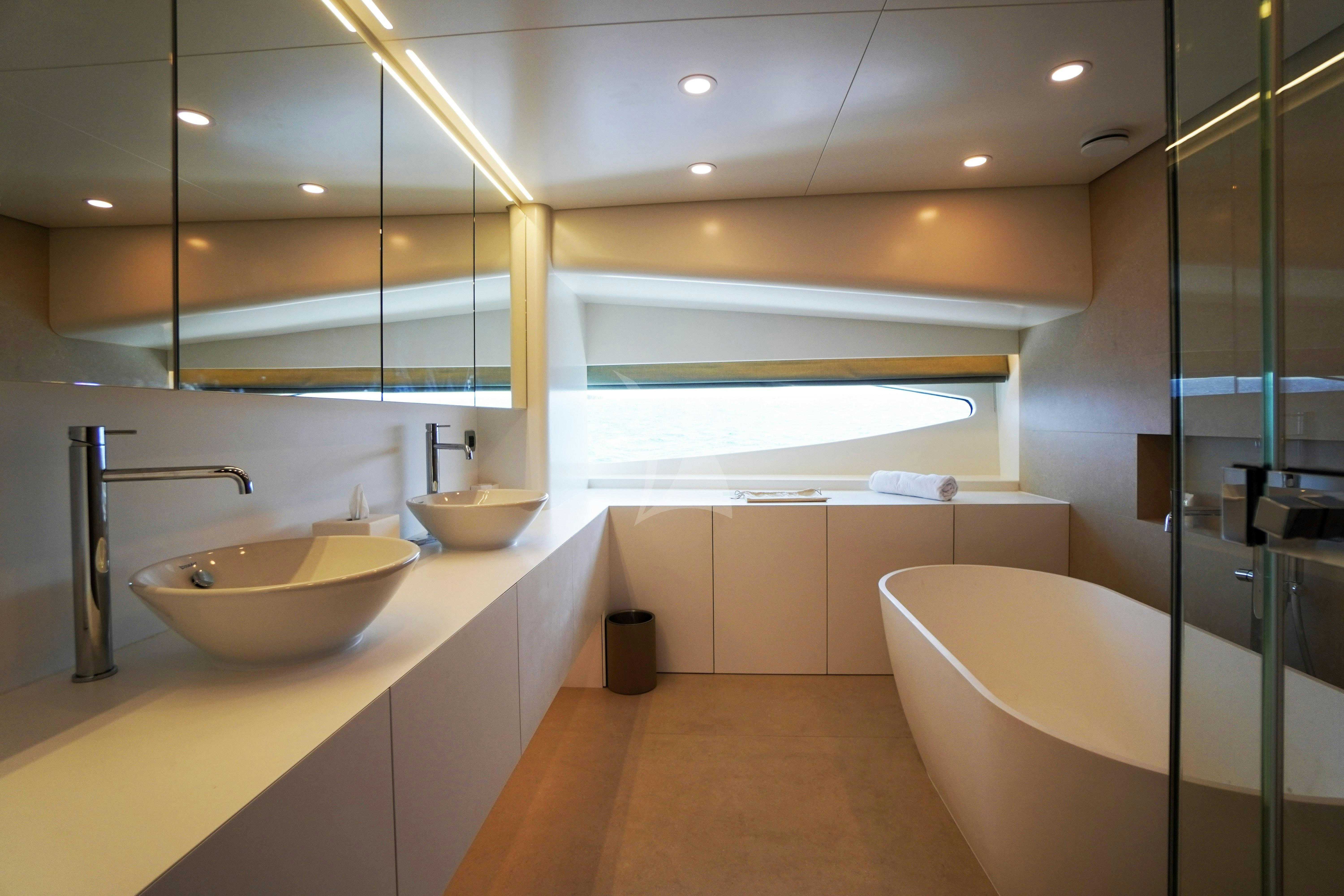 a bathroom with a sink and a bathtub aboard UNEXPECTED Yacht for Charter