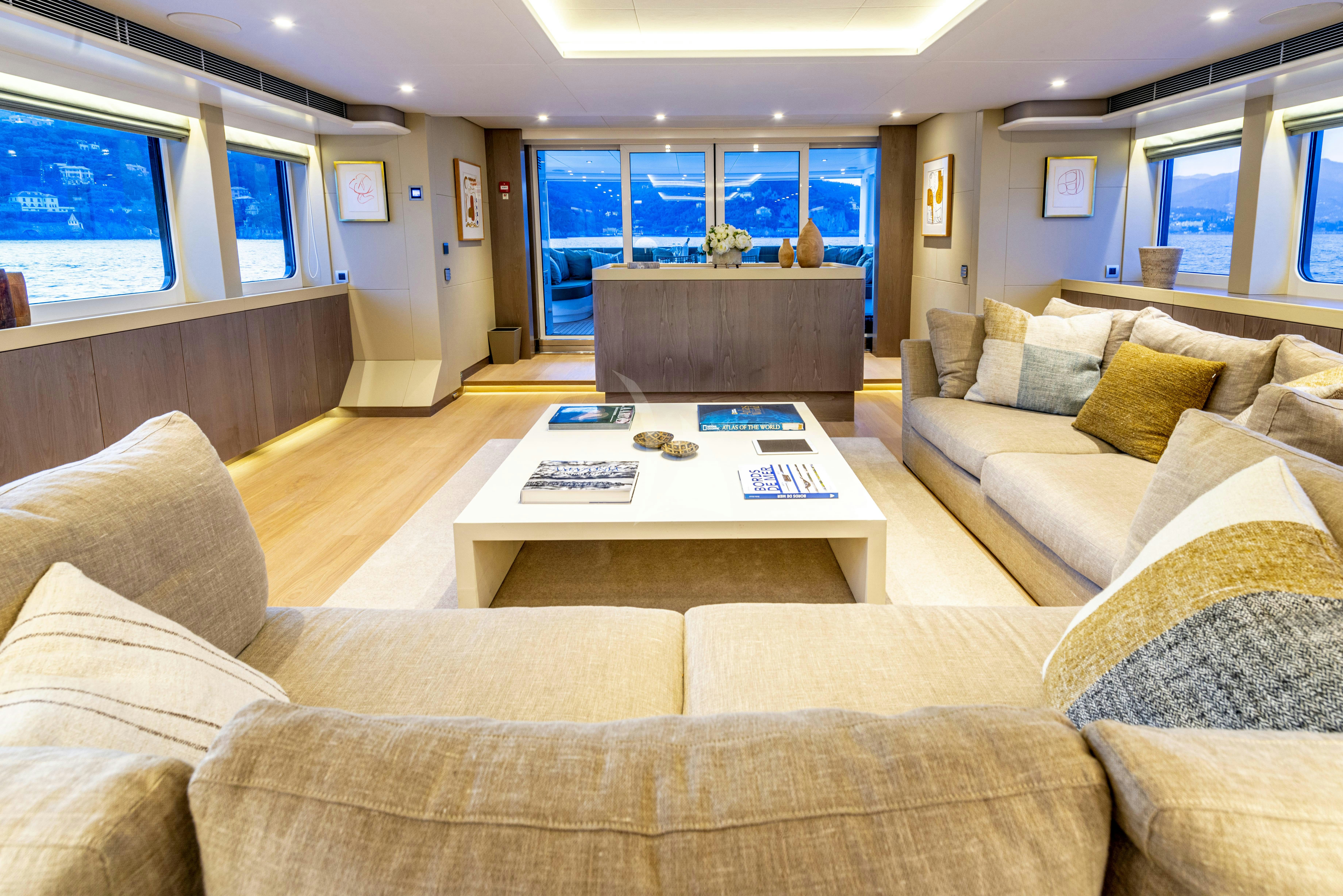 a living room with a large window aboard UNEXPECTED Yacht for Charter