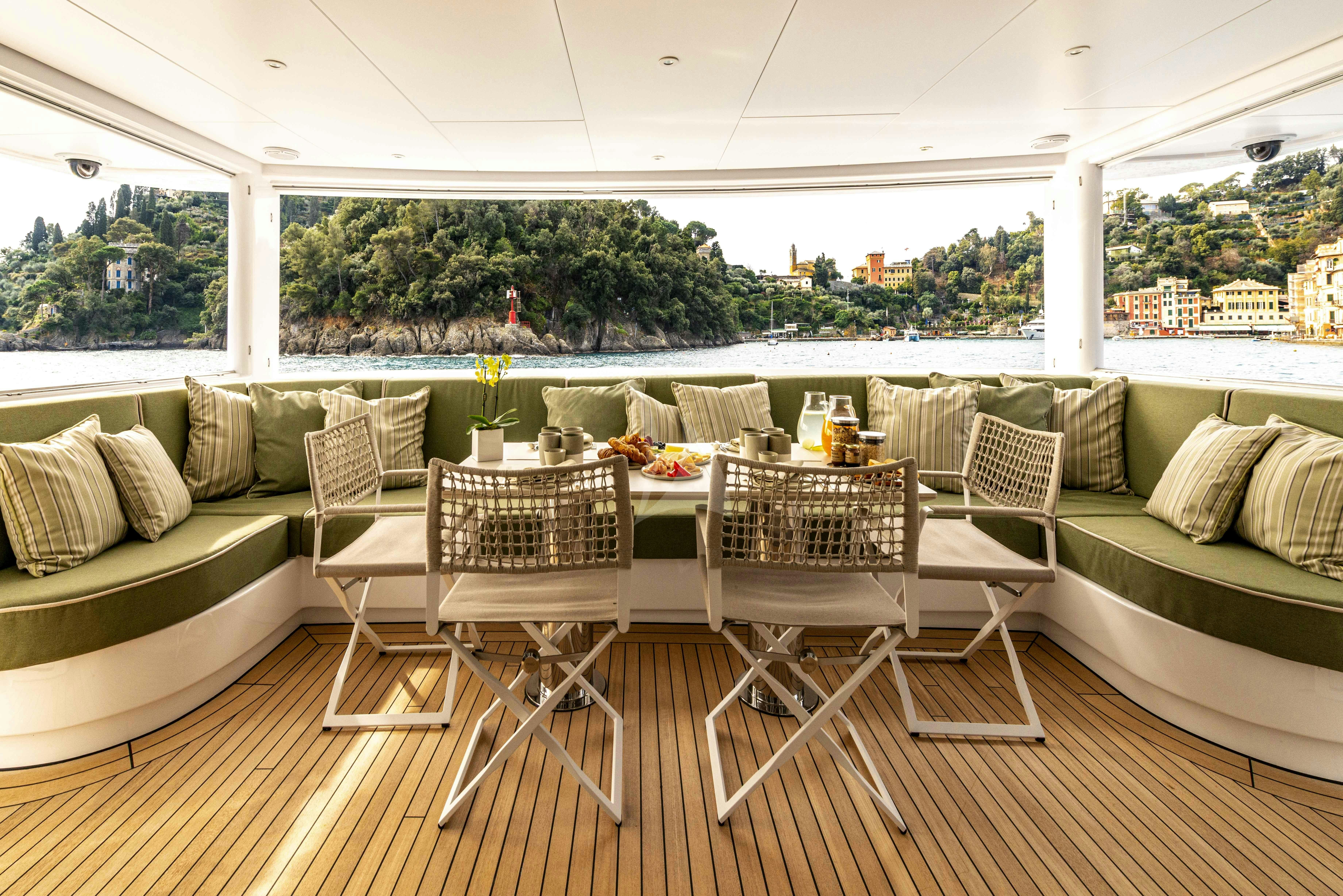 a table and chairs on a deck aboard UNEXPECTED Yacht for Charter