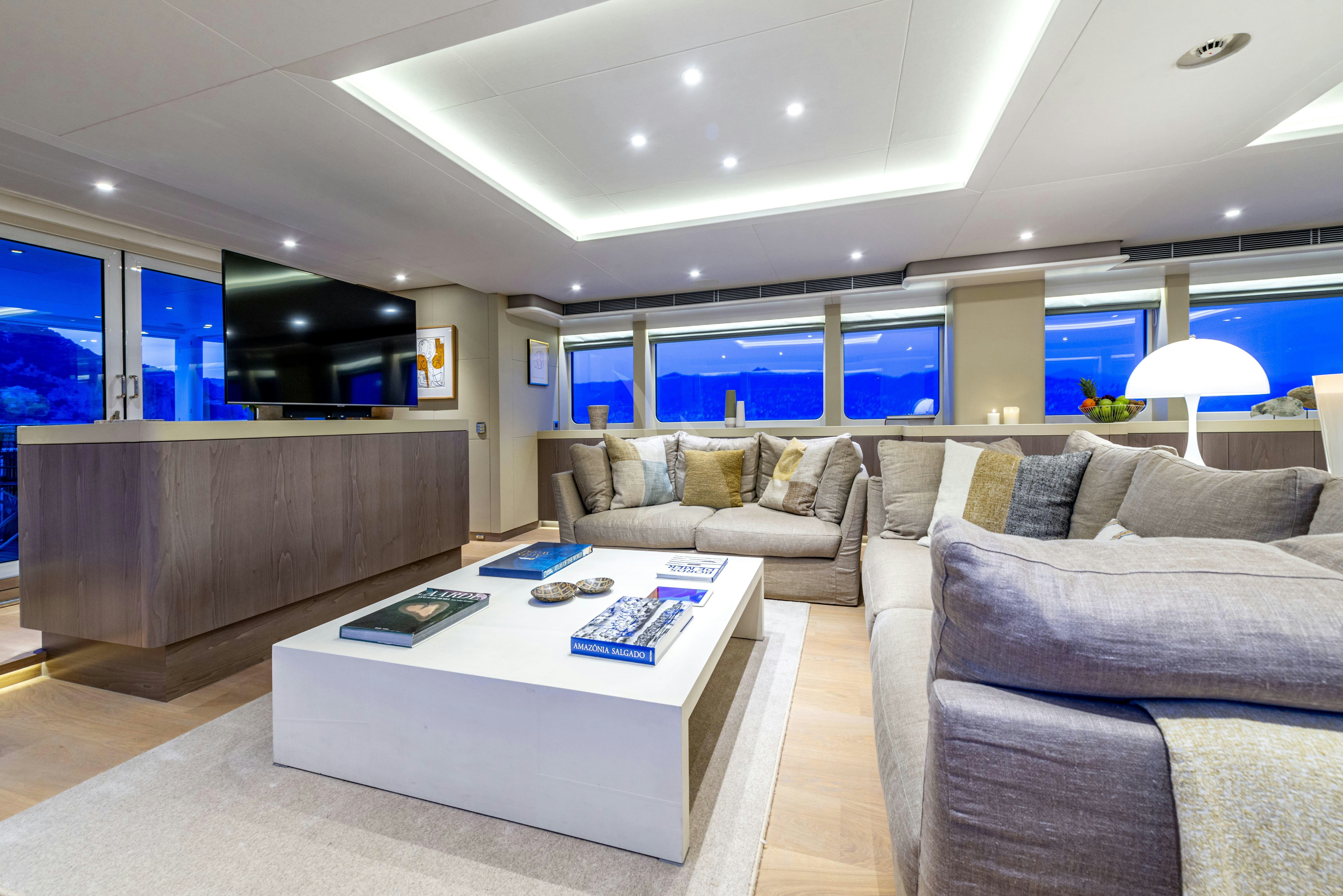 a living room with a couch and a table aboard UNEXPECTED Yacht for Charter