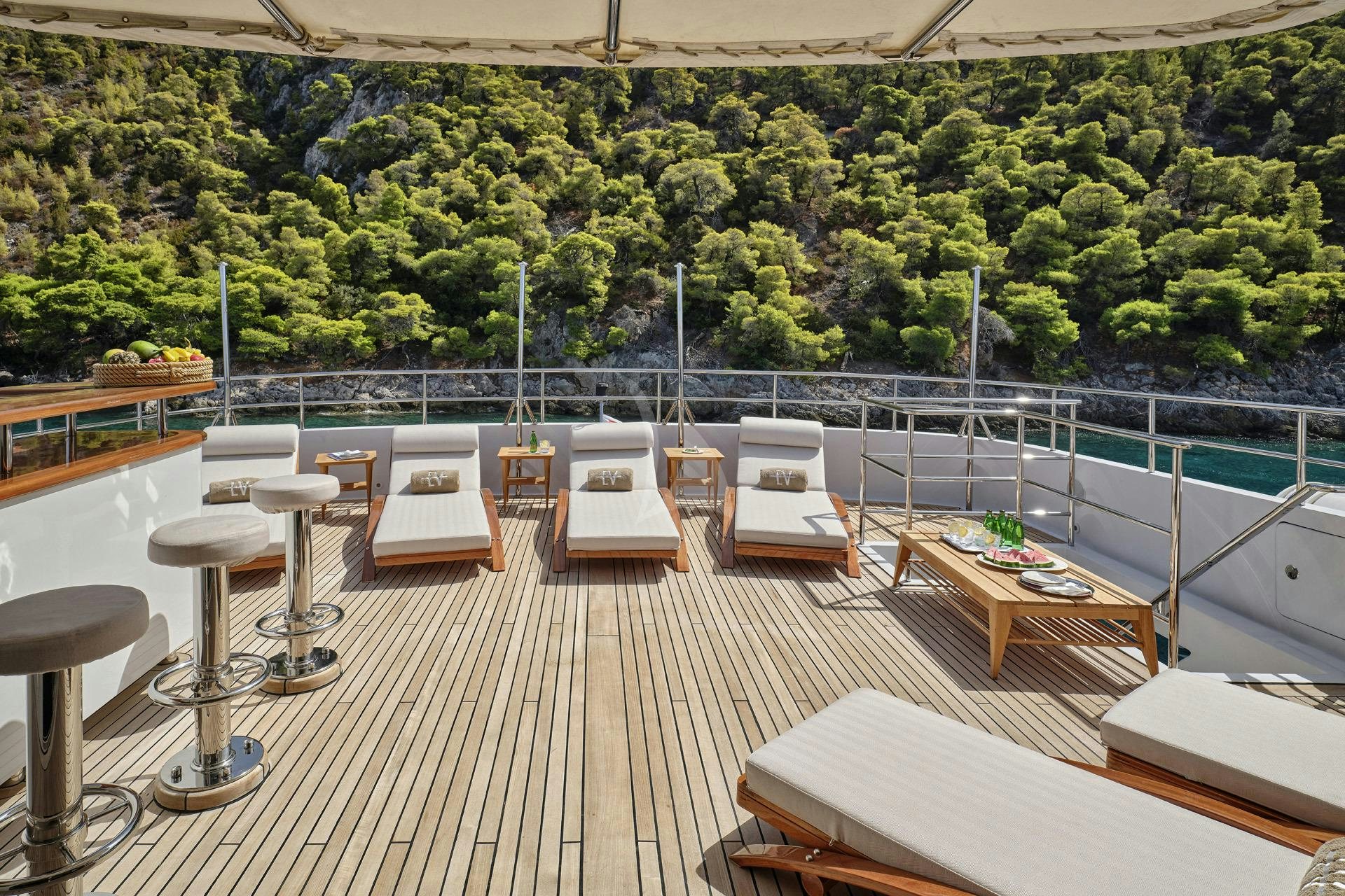 a deck with tables and chairs aboard ELENA V Yacht for Charter