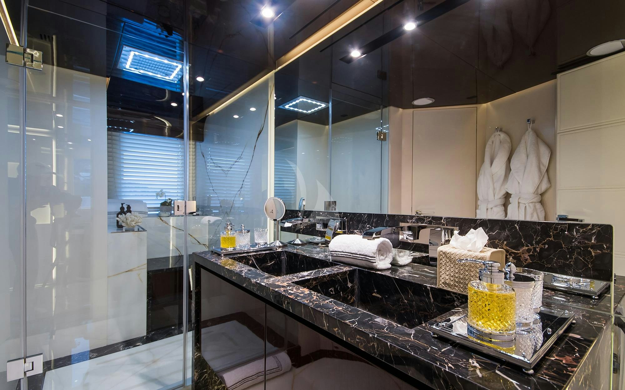 a bathroom with a countertop sink and a large mirror aboard SOULMATE Yacht for Charter
