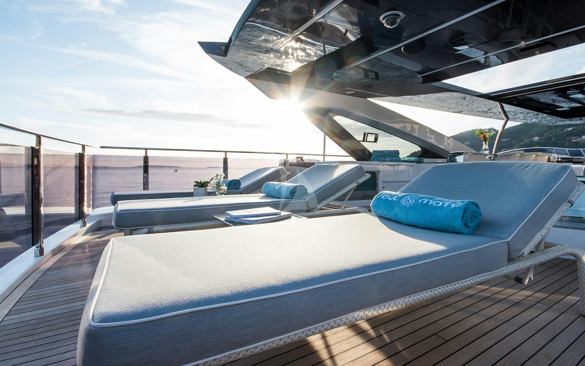 a deck with a pool and a plane in the background aboard SOULMATE Yacht for Charter