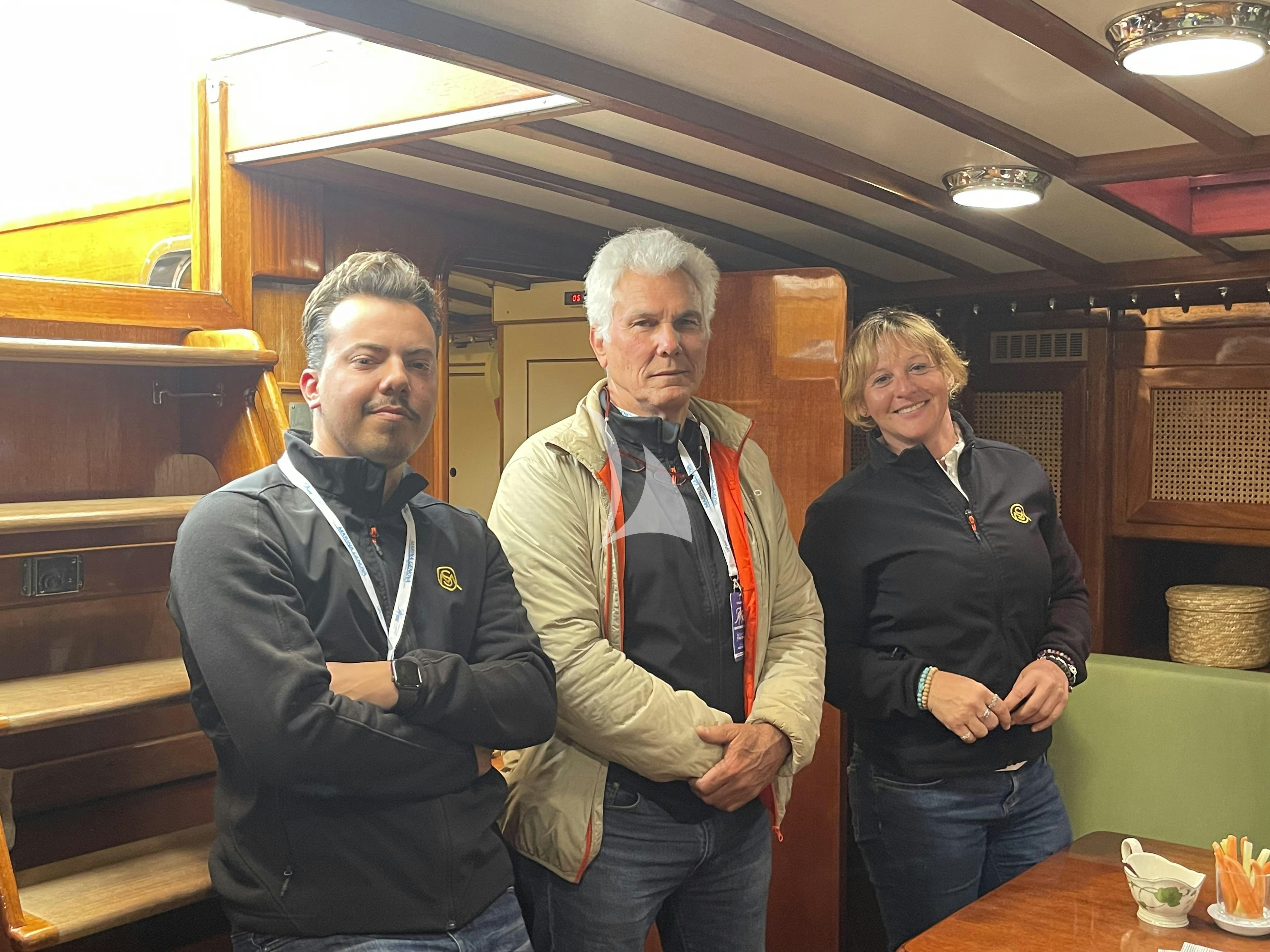 a group of people standing in a room aboard QUARTA SANTA MARIA Yacht for Sale