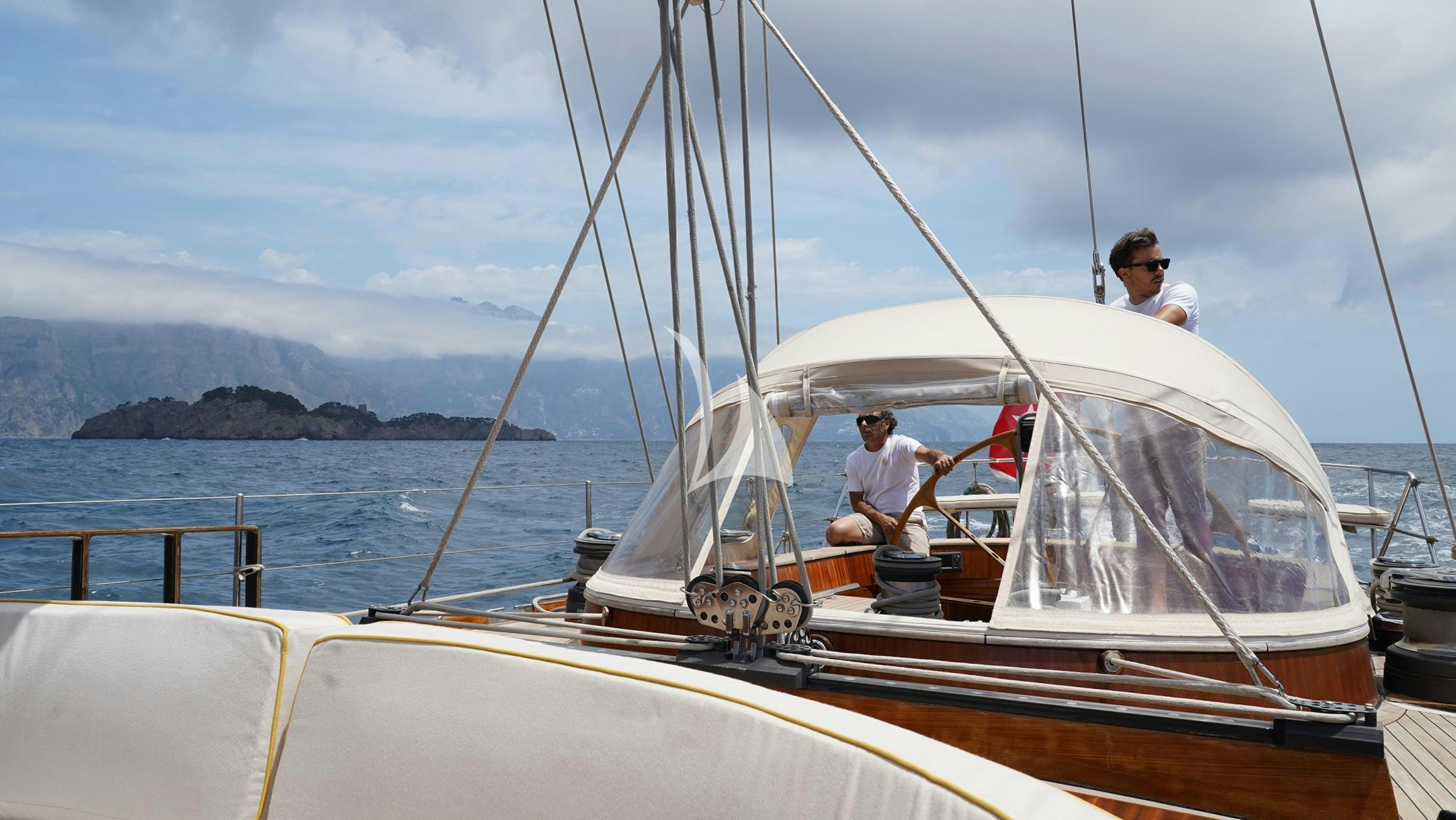 a couple men on a sailboat aboard QUARTA SANTA MARIA Yacht for Sale