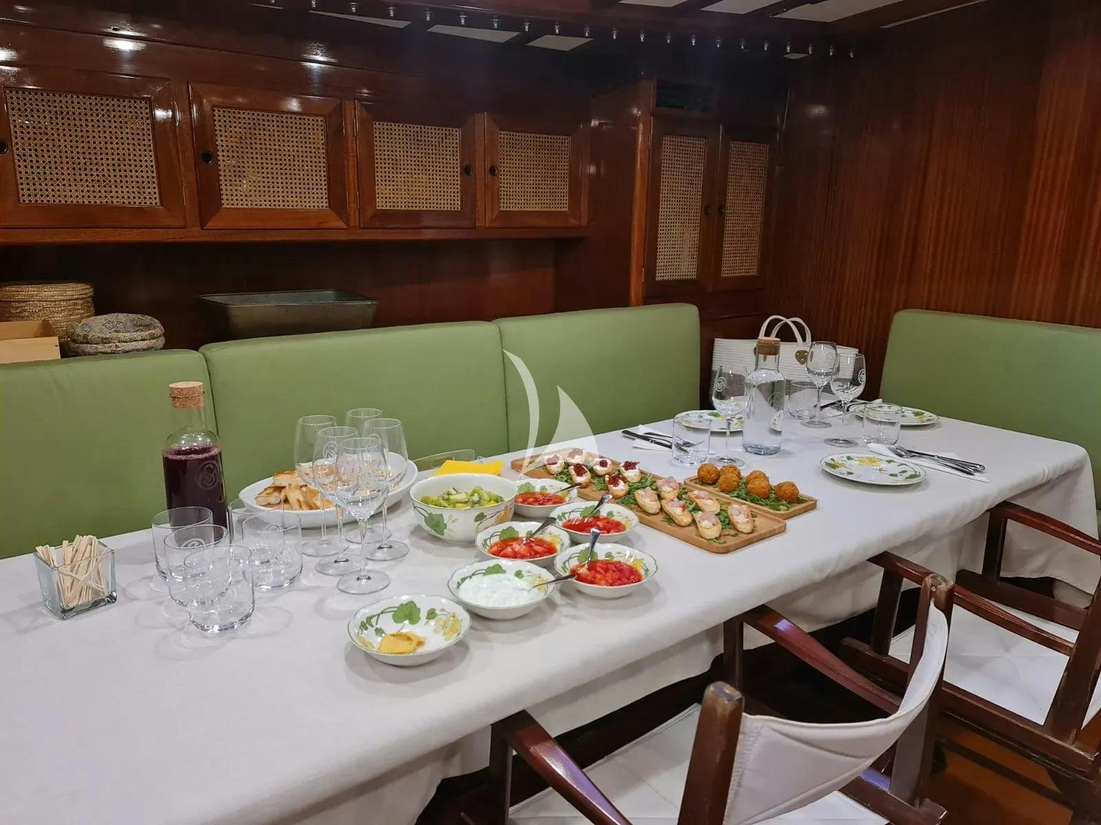 a table set with food aboard QUARTA SANTA MARIA Yacht for Sale