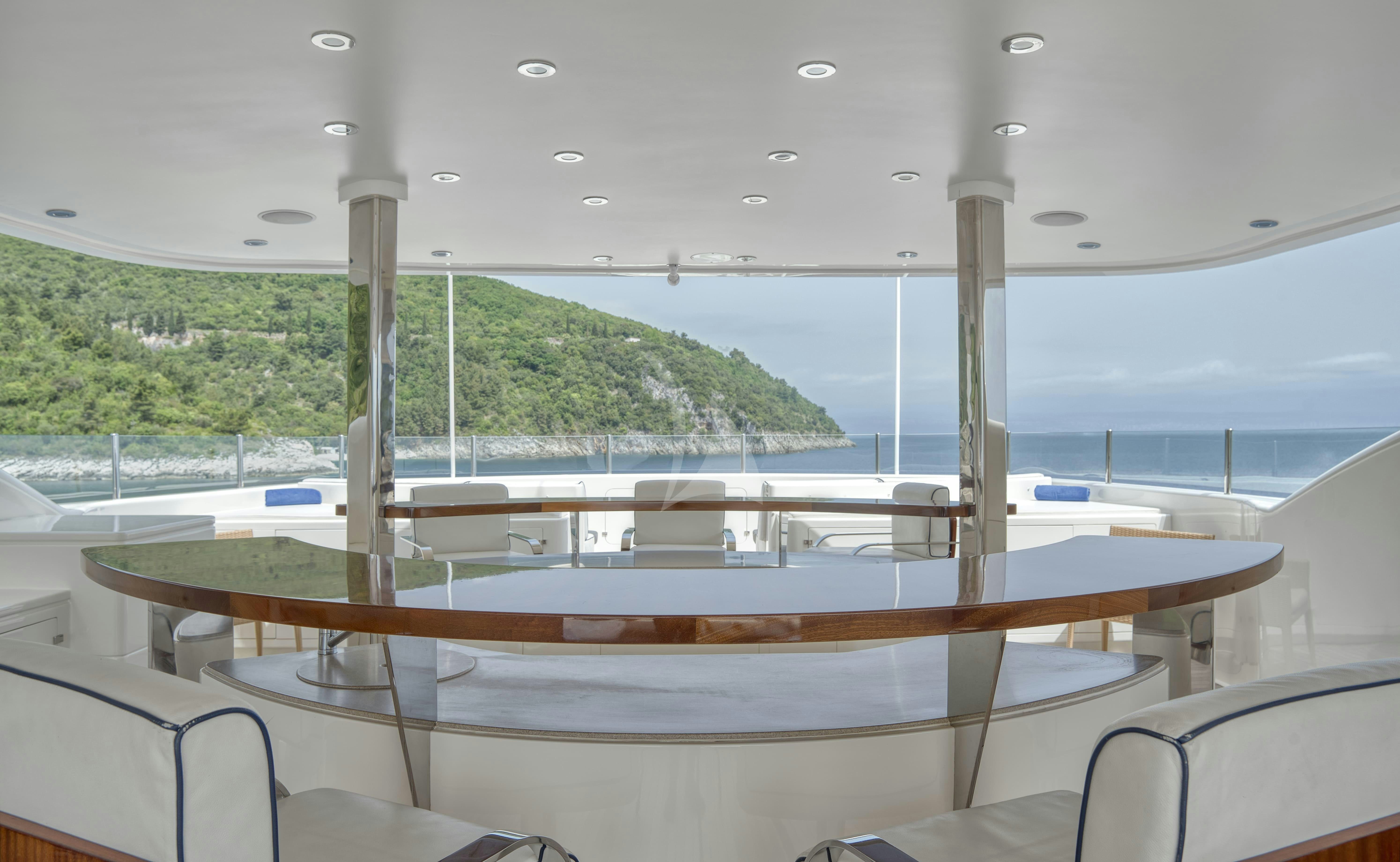 a deck with a view of a mountain and water aboard TIREA Yacht for Charter
