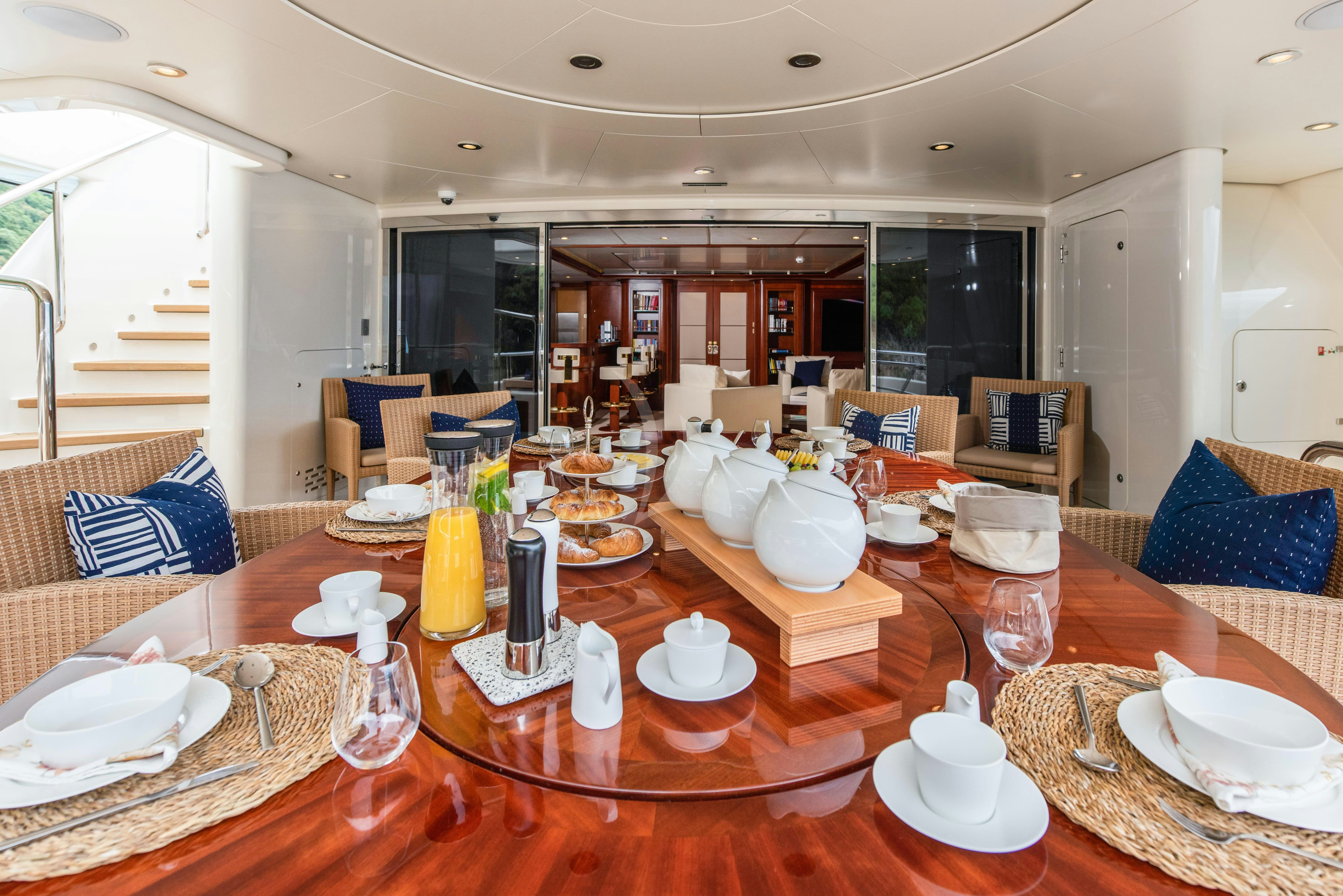 a table with plates and glasses on it aboard TIREA Yacht for Charter