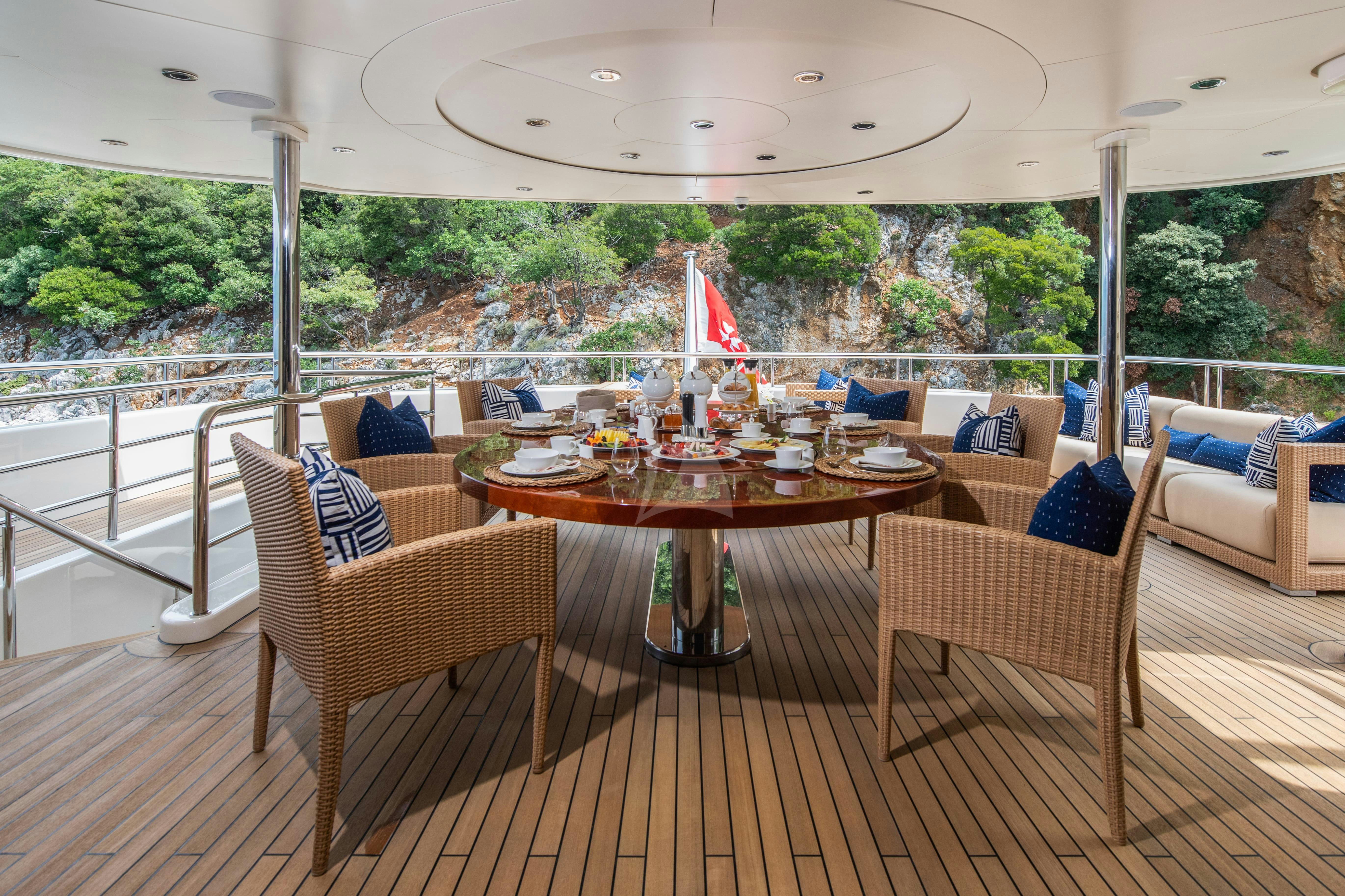 a patio with a table and chairs aboard TIREA Yacht for Charter
