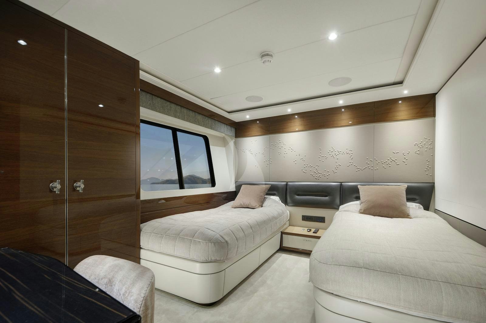 a room with a bed and a tv aboard ANTHEYA III Yacht for Charter