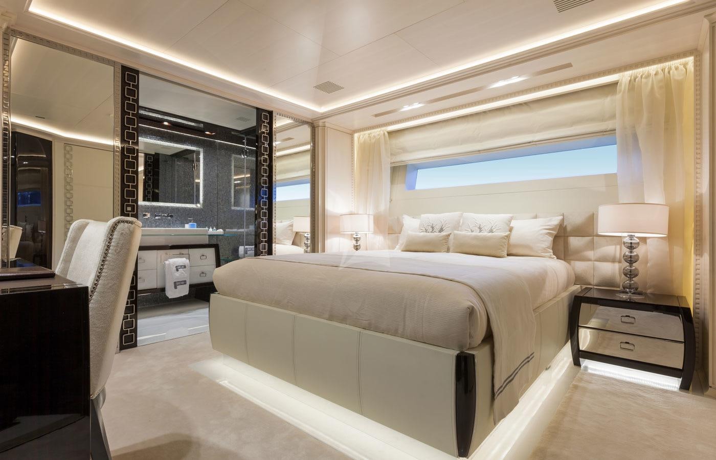 a hotel room with a bed and a desk aboard PARILLION Yacht for Charter