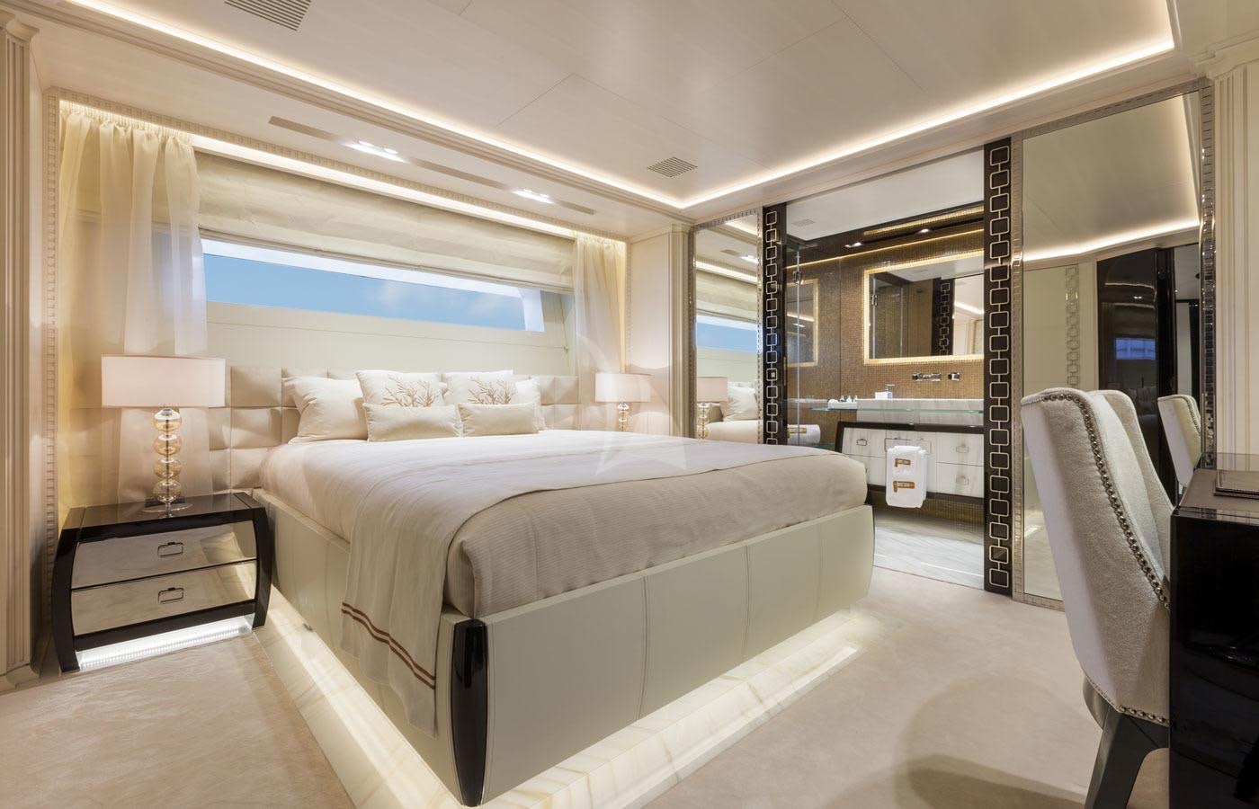 a room with a bed and a desk aboard PARILLION Yacht for Charter