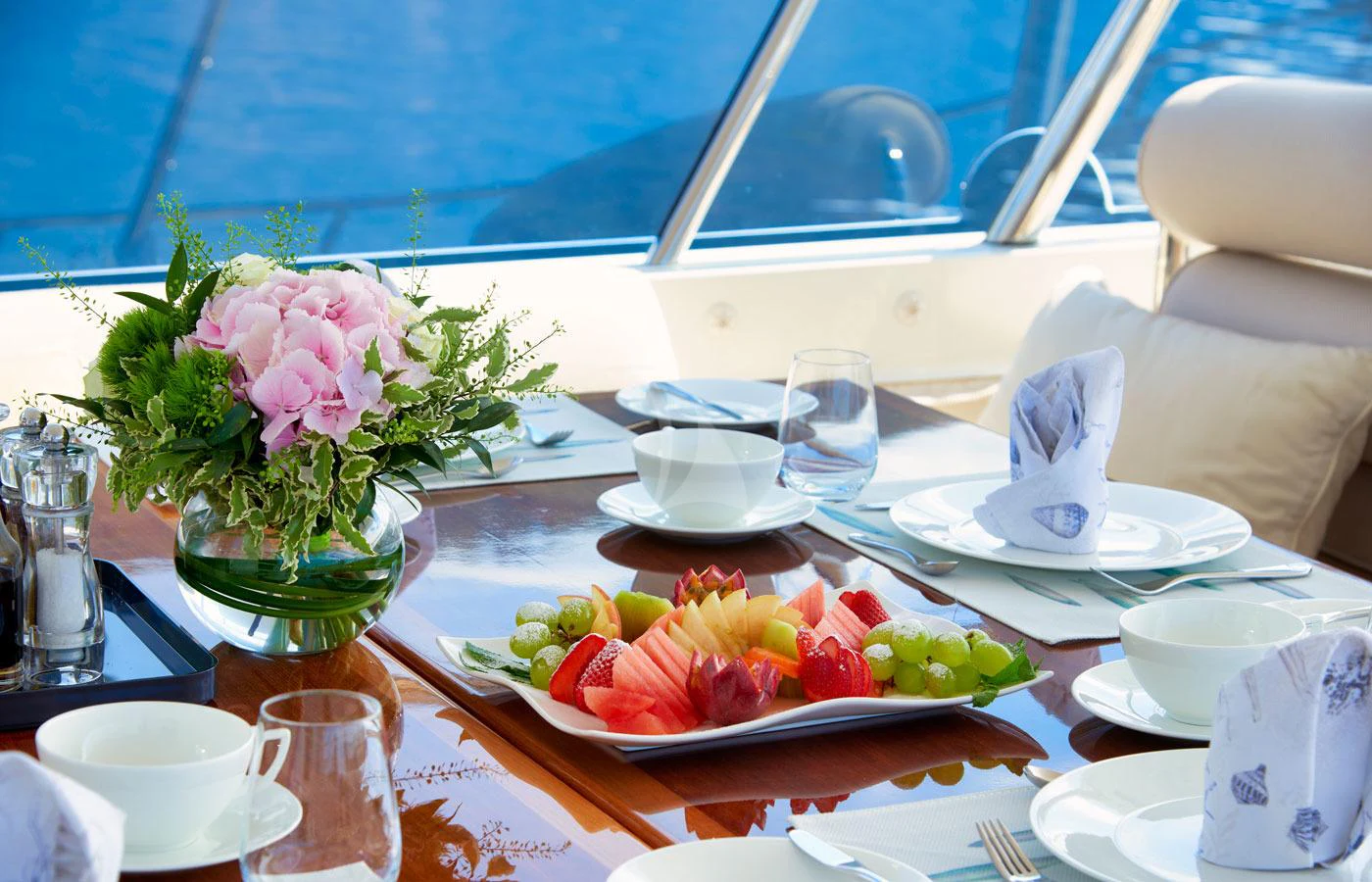 a table with plates and food on it aboard GALENA Yacht for Charter
