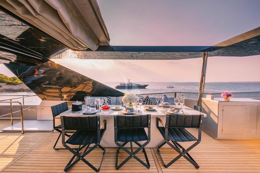 a table set for a meal aboard OVAL Yacht for Charter