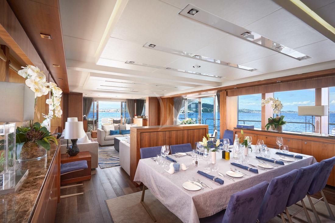 a dining room with a large table aboard EVEREAST Yacht for Charter