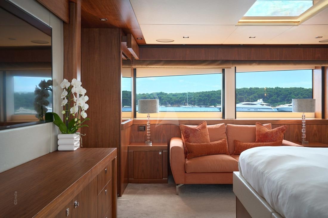 a living room with a large window aboard EVEREAST Yacht for Charter