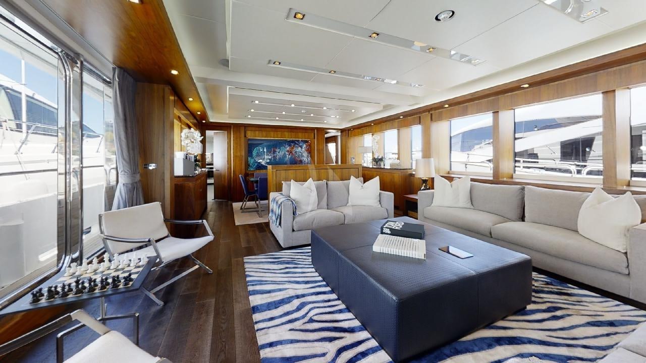 a large room with a couch and a table aboard EVEREAST Yacht for Charter