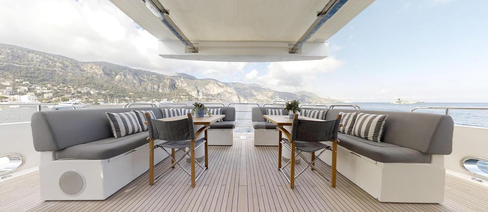 a room with a couch and a table and chairs aboard EVEREAST Yacht for Charter