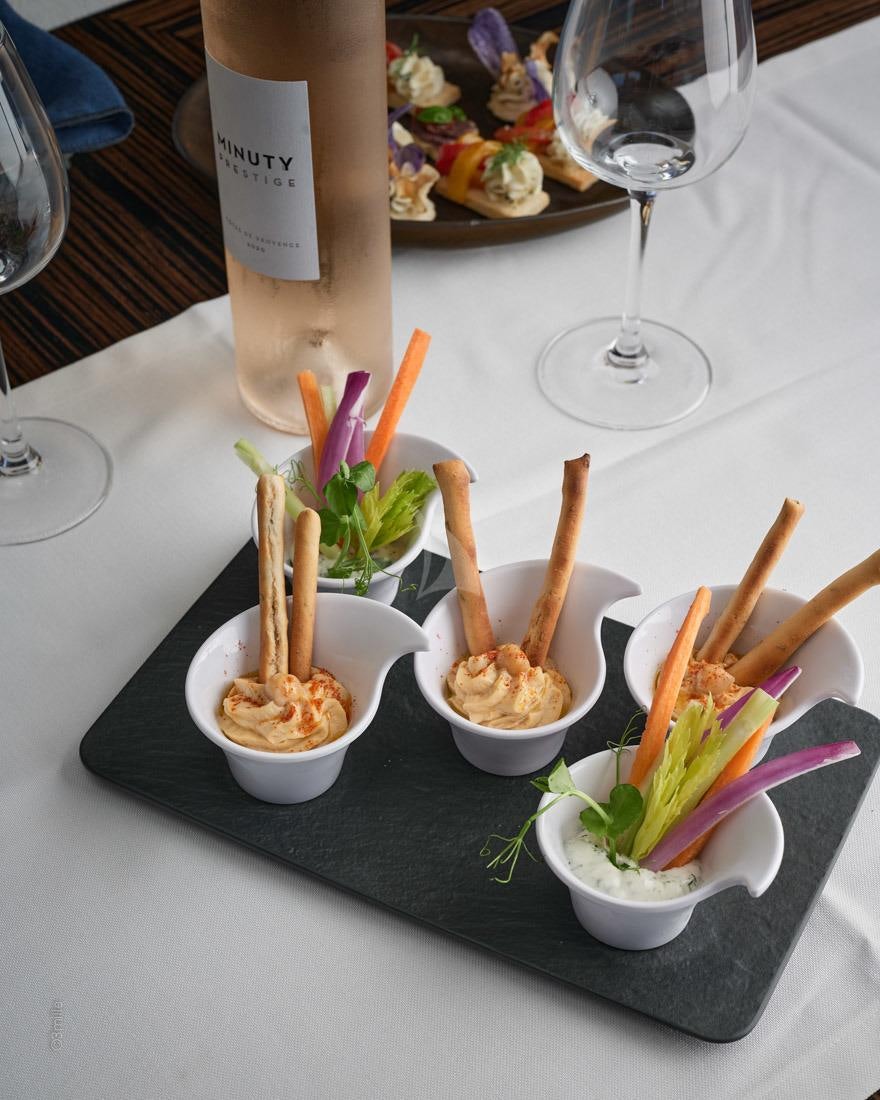 a table with food and drinks aboard EVEREAST Yacht for Charter