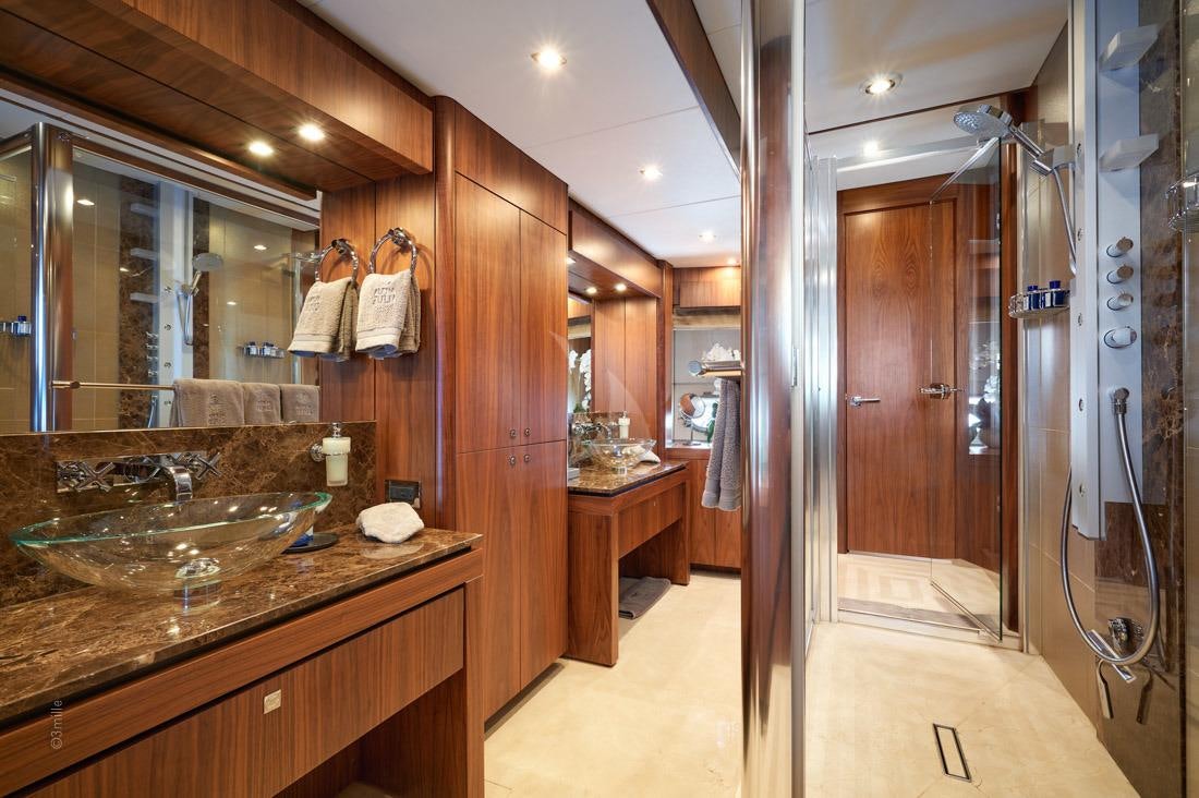 a bathroom with a sink and a shower aboard EVEREAST Yacht for Charter