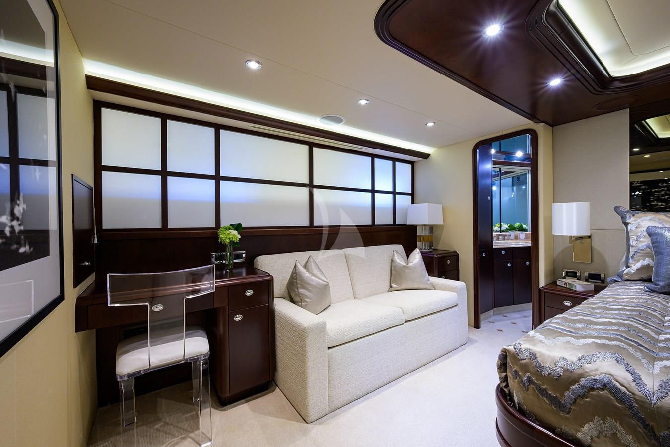 a bedroom with a bed and desk aboard UNWINED Yacht for Charter