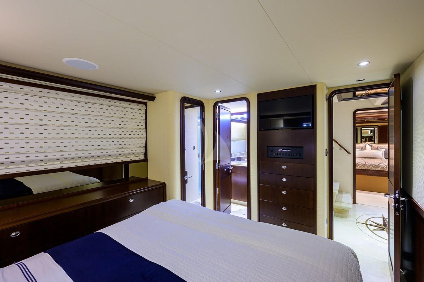 a hotel room with a bed and a mirror aboard UNWINED Yacht for Charter