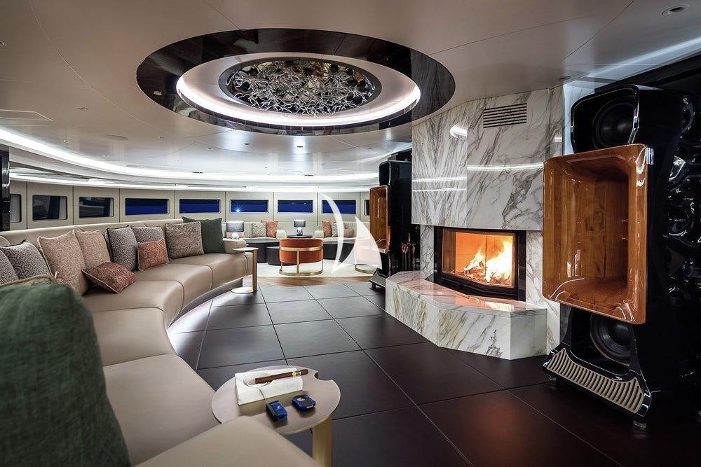 a living room with a fireplace aboard VICTORIOUS Yacht for Sale