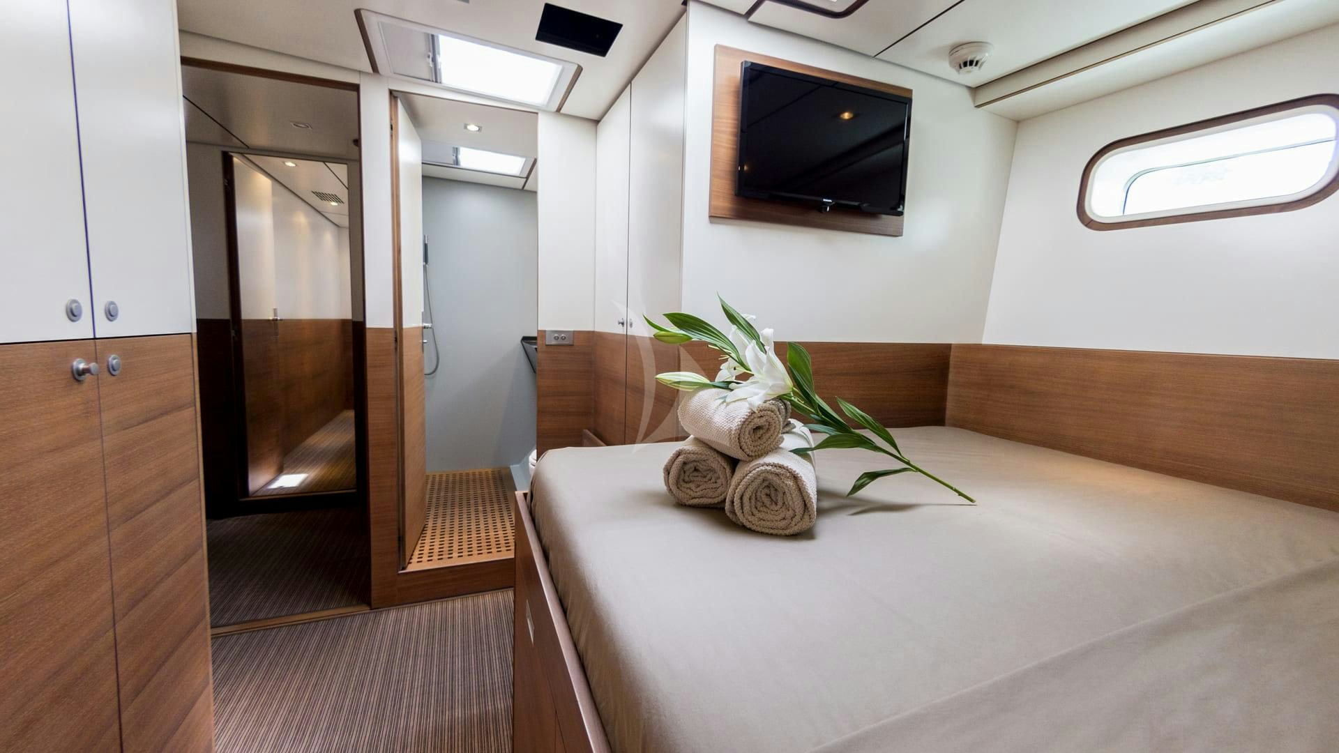 a room with a tv and a plant in it aboard AIZU Yacht for Sale
