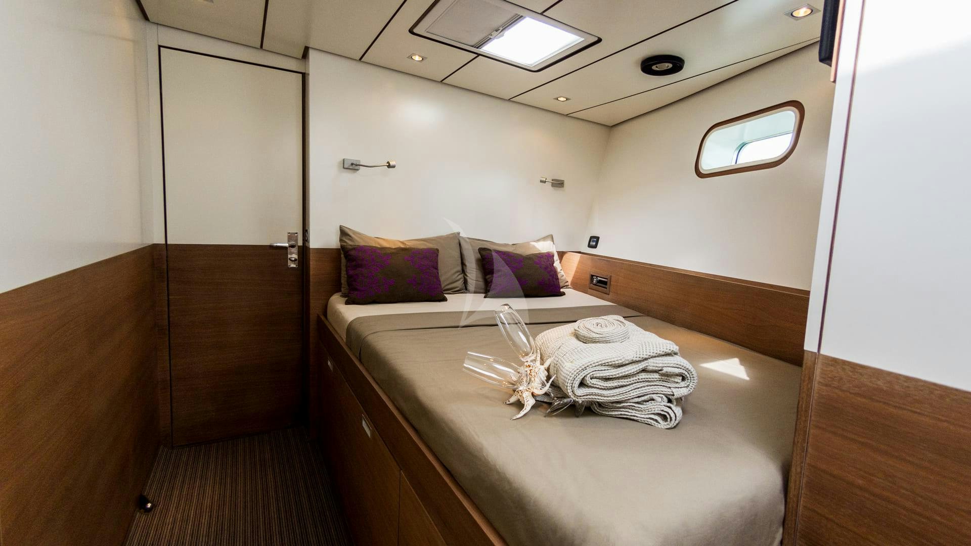 a bed in a room aboard AIZU Yacht for Sale