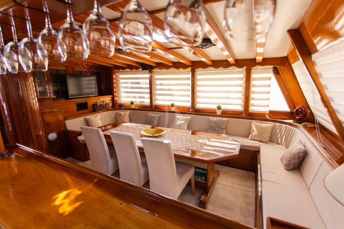 a dining room with a large chandelier aboard KADENA Yacht for Charter
