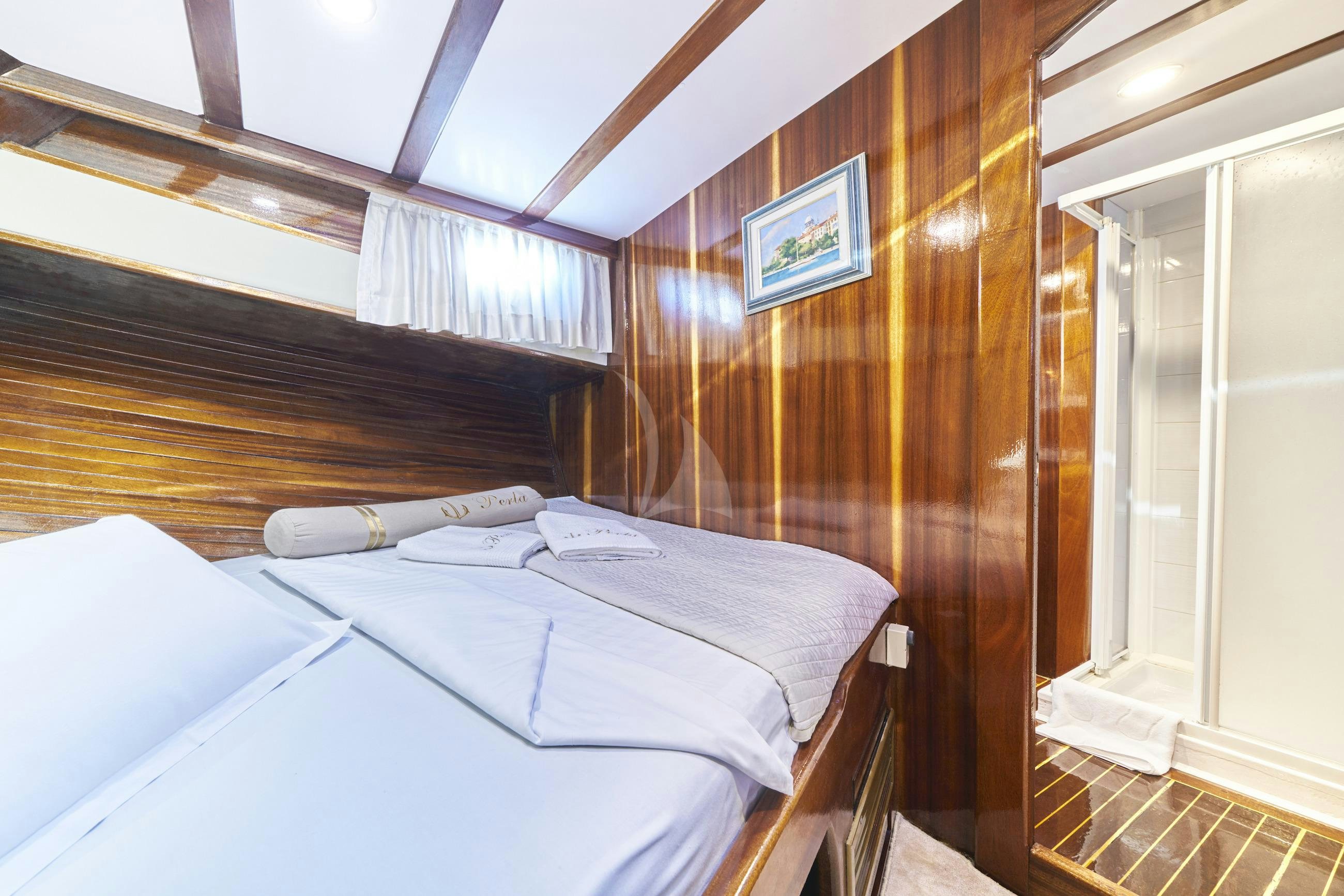 a room with a bed and a window aboard PERLA Yacht for Charter