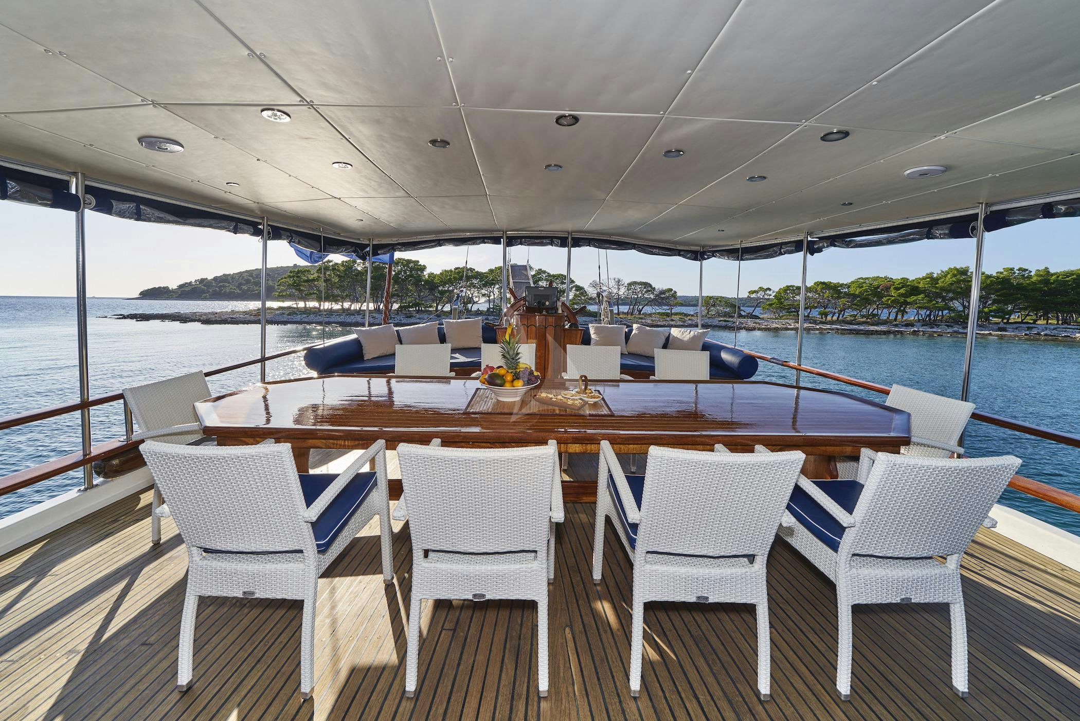 a table with chairs on it aboard PERLA Yacht for Charter