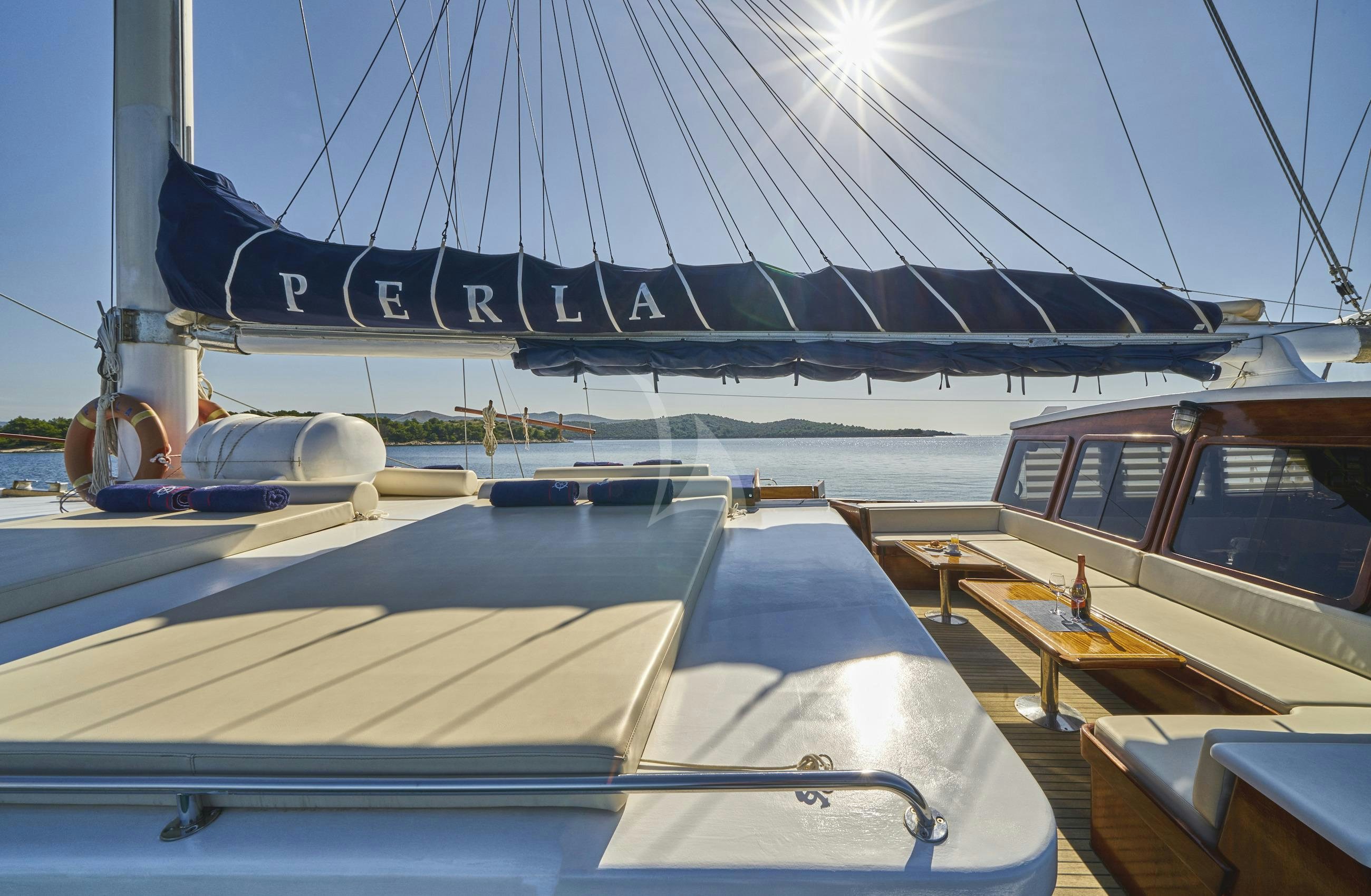 a boat docked at a pier aboard PERLA Yacht for Charter