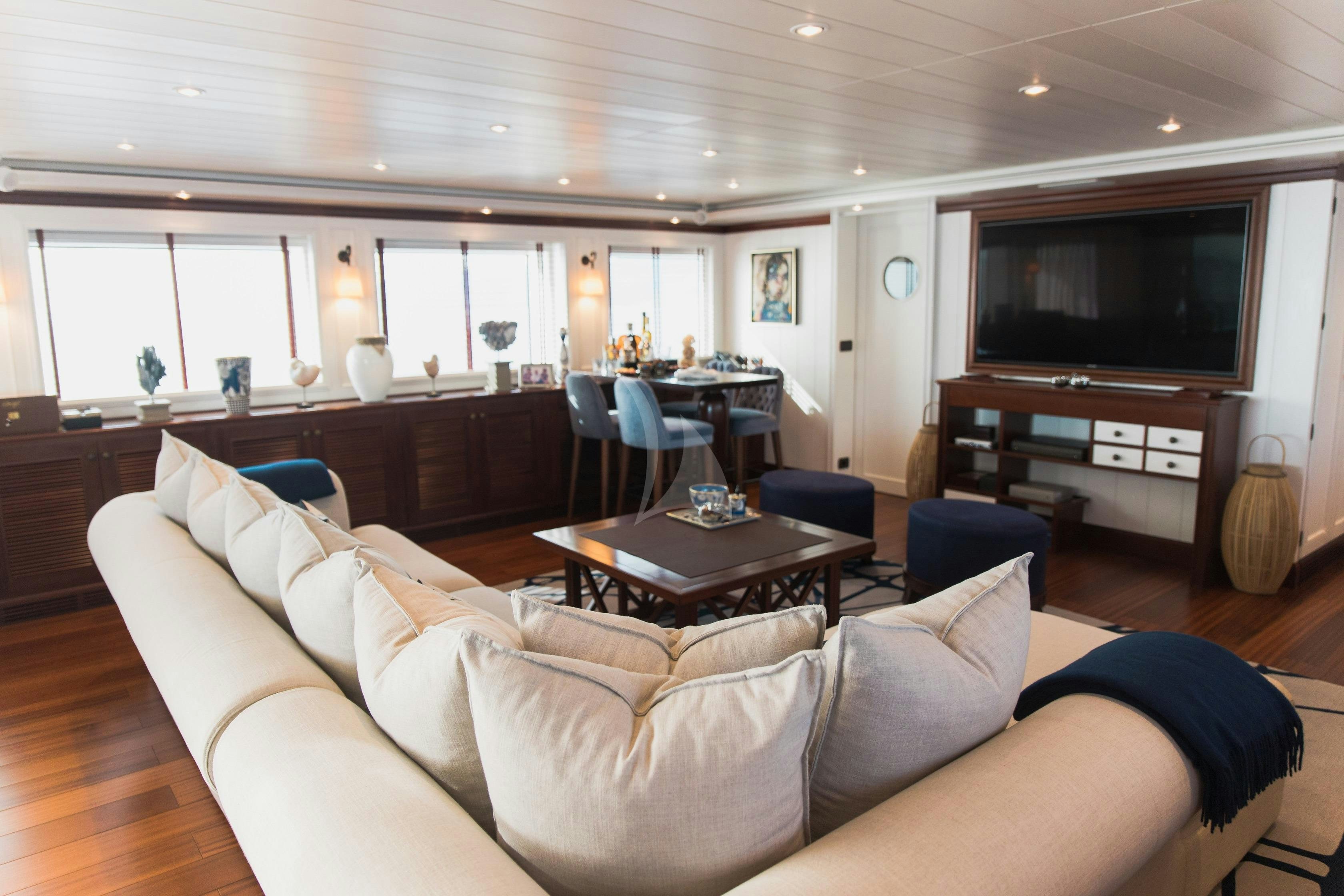 a living room with a large sofa aboard LADY TRUDY Yacht for Charter