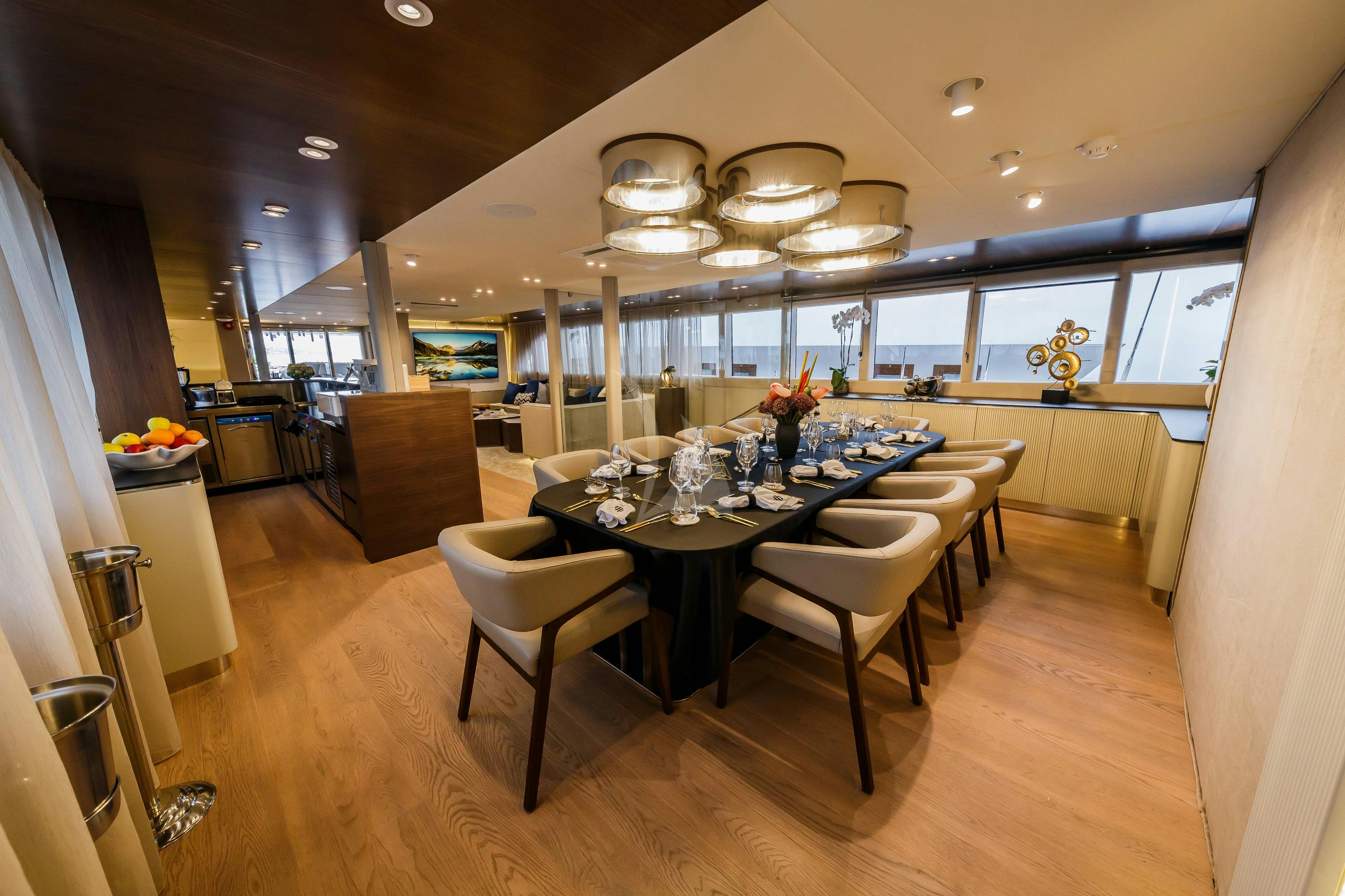 a dining room with a table and chairs aboard CLASE AZUL Yacht for Charter