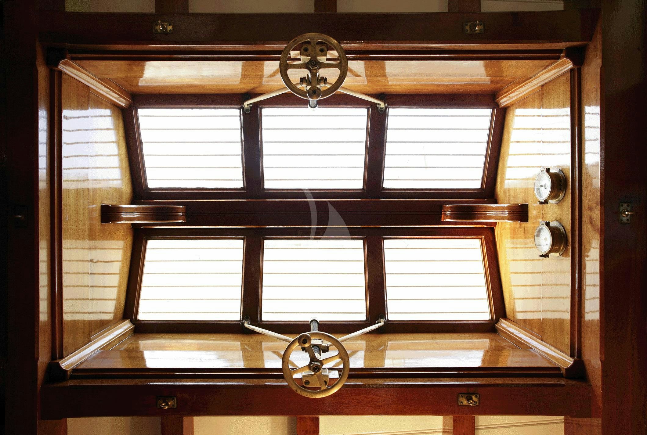 a clock on a window aboard AELLO Yacht for Charter