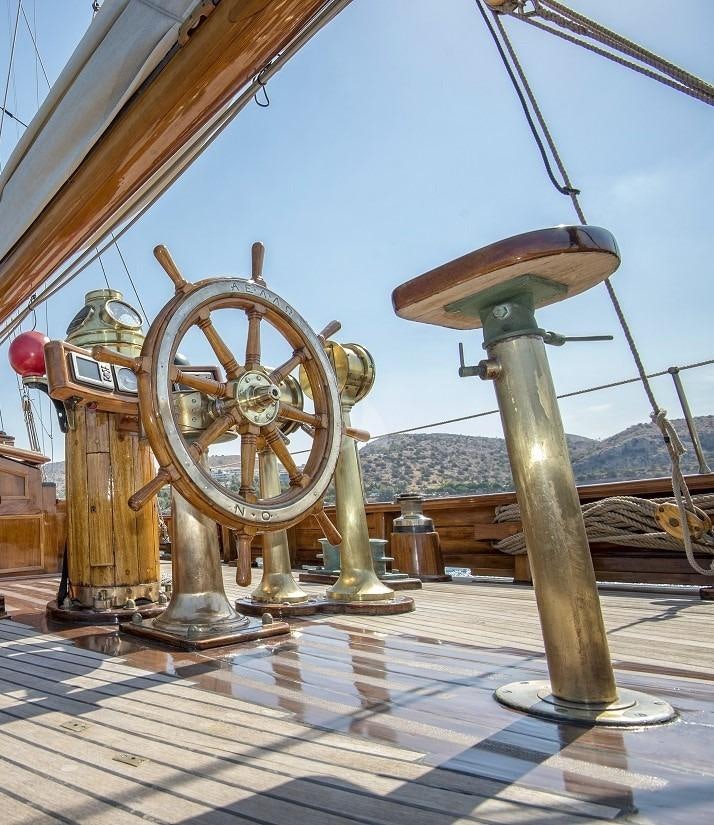a large metal wheel aboard AELLO Yacht for Charter