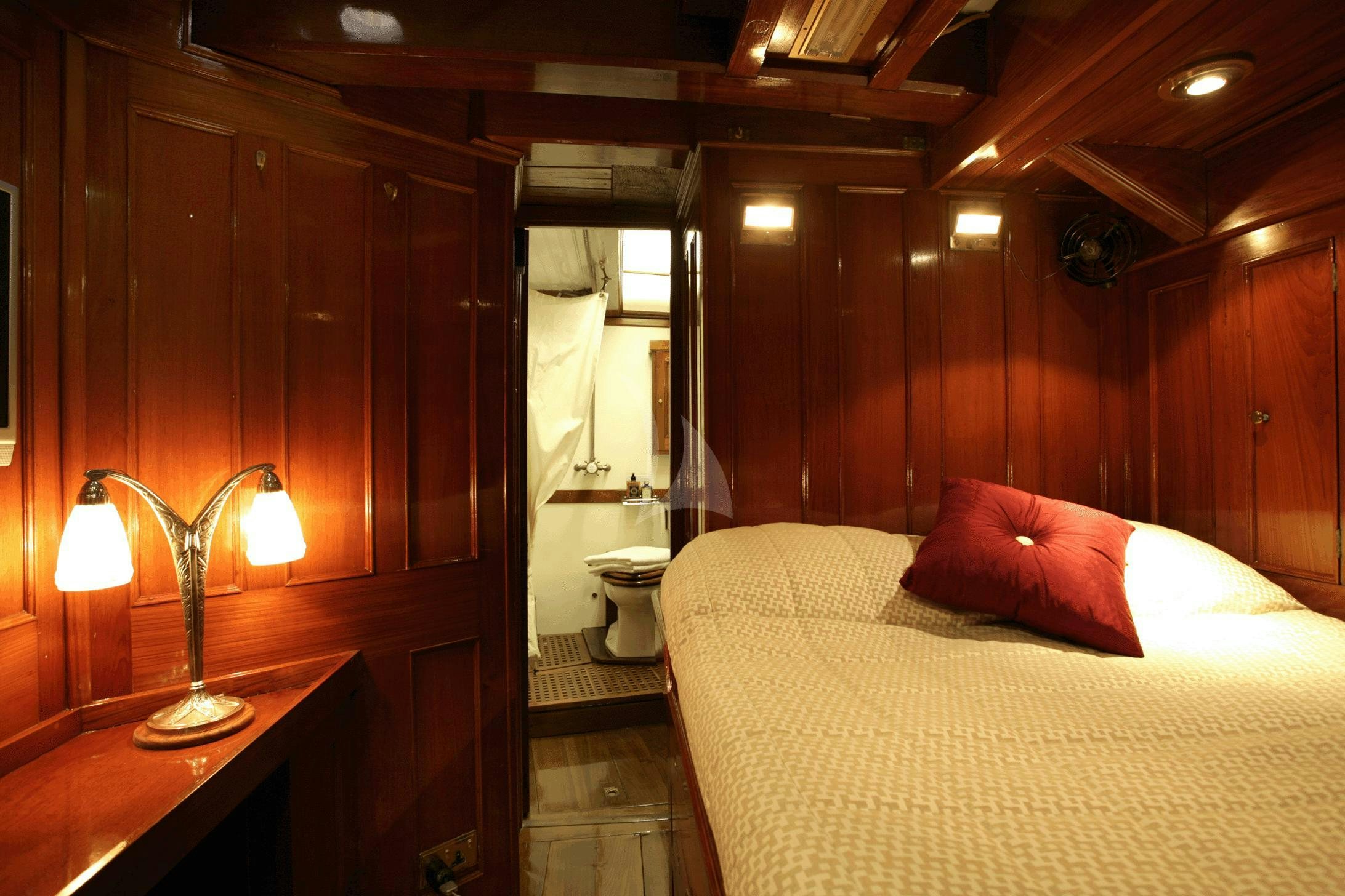 a bed in a room aboard AELLO Yacht for Charter