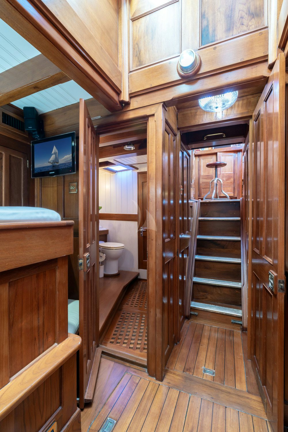 a bathroom with a wood door aboard AELLO Yacht for Charter