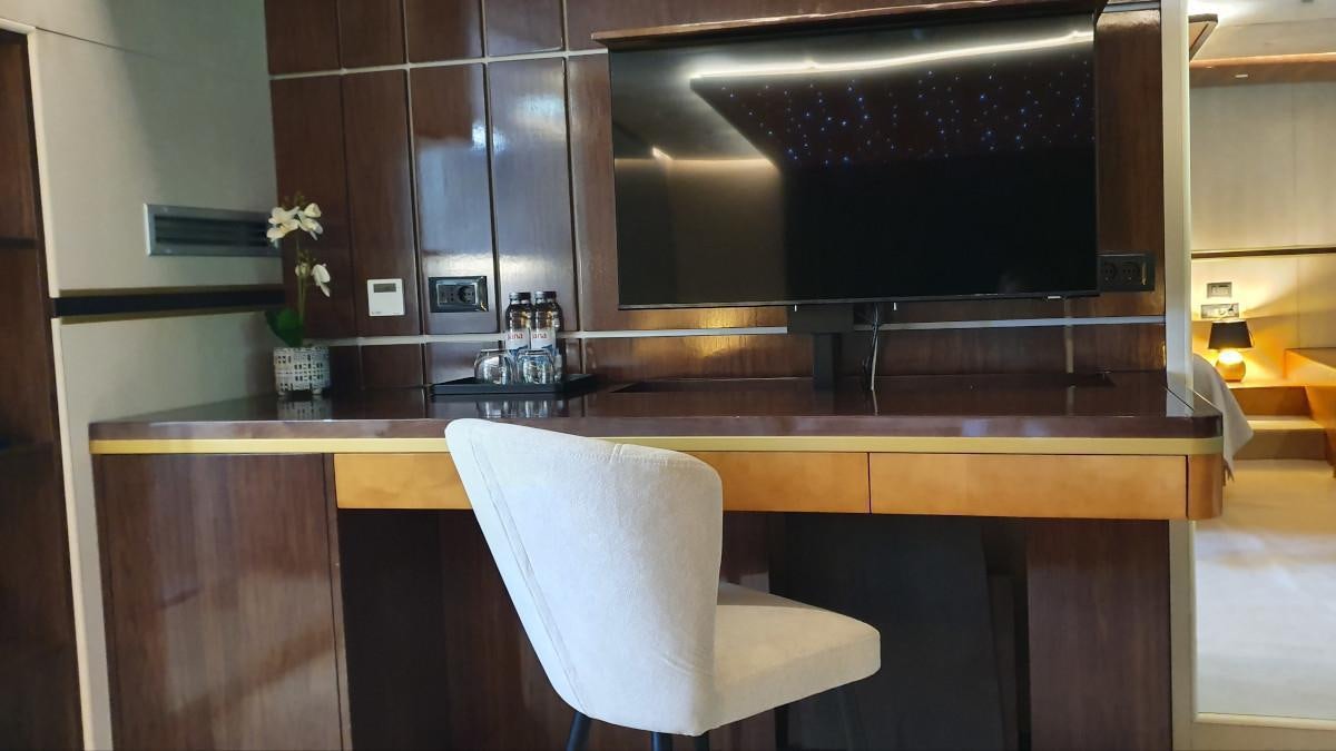 a room with a tv and a chair aboard LIFE IS GOOD Yacht for Charter