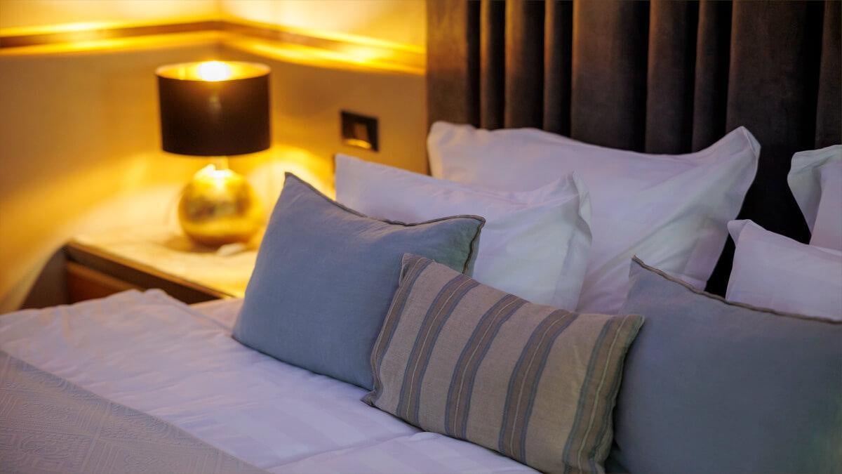 a bed with pillows aboard LIFE IS GOOD Yacht for Charter