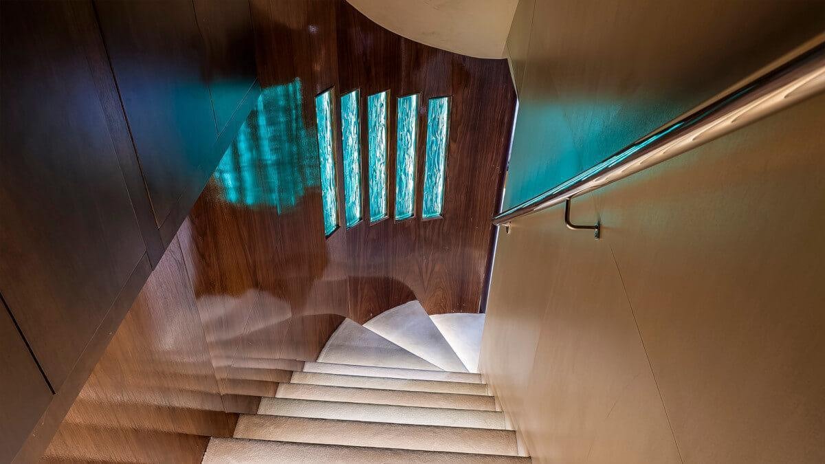 a staircase with a blue light aboard LIFE IS GOOD Yacht for Charter