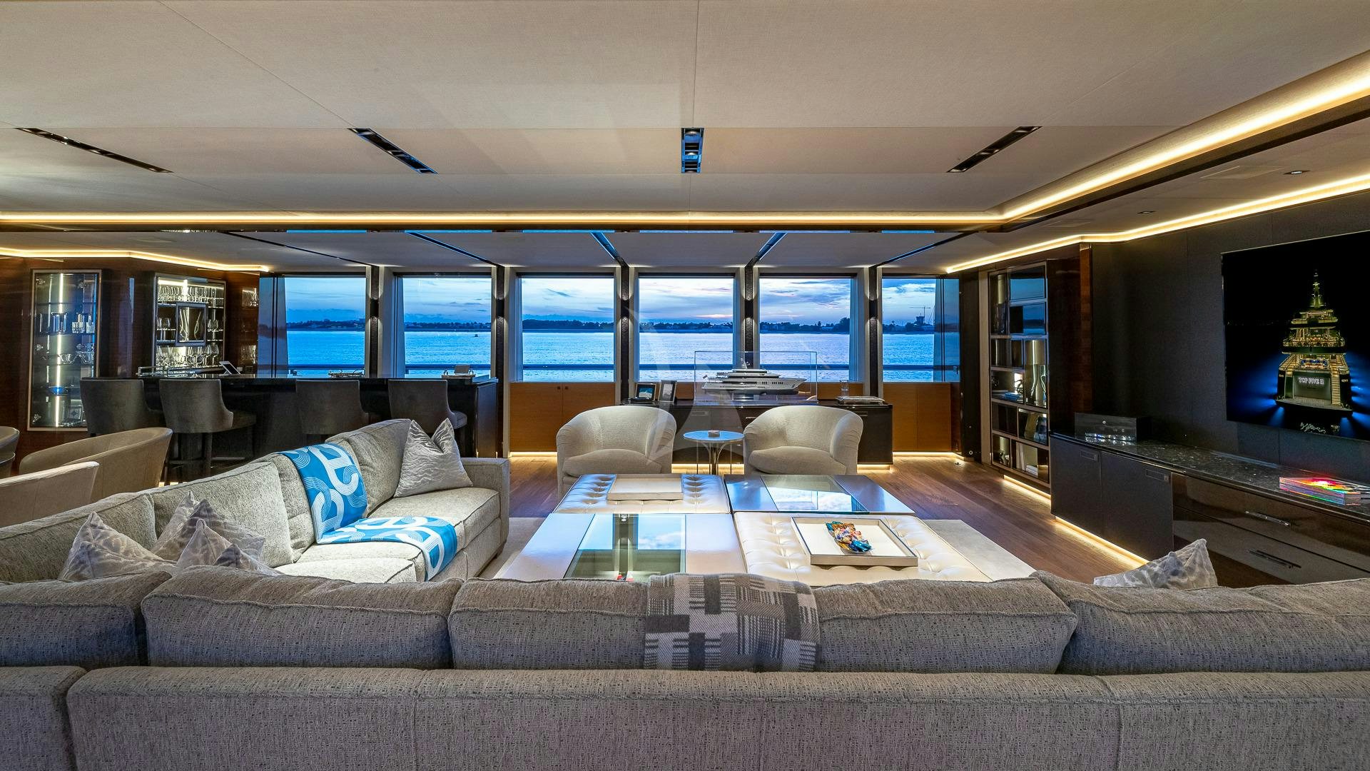 a living room with a large sofa aboard TOP FIVE II Yacht for Charter