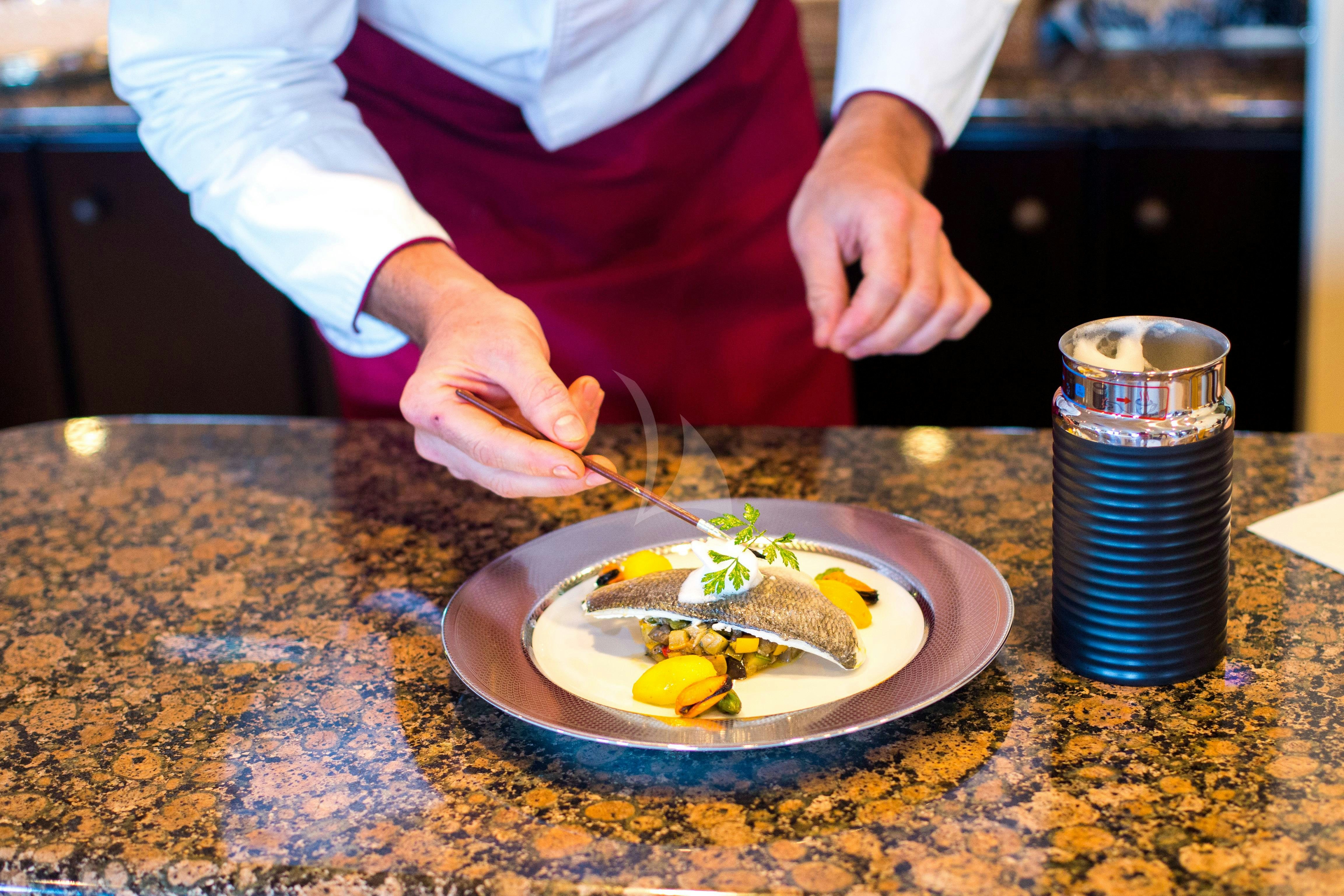 a person cutting a cake aboard ESMERALDA Yacht for Charter
