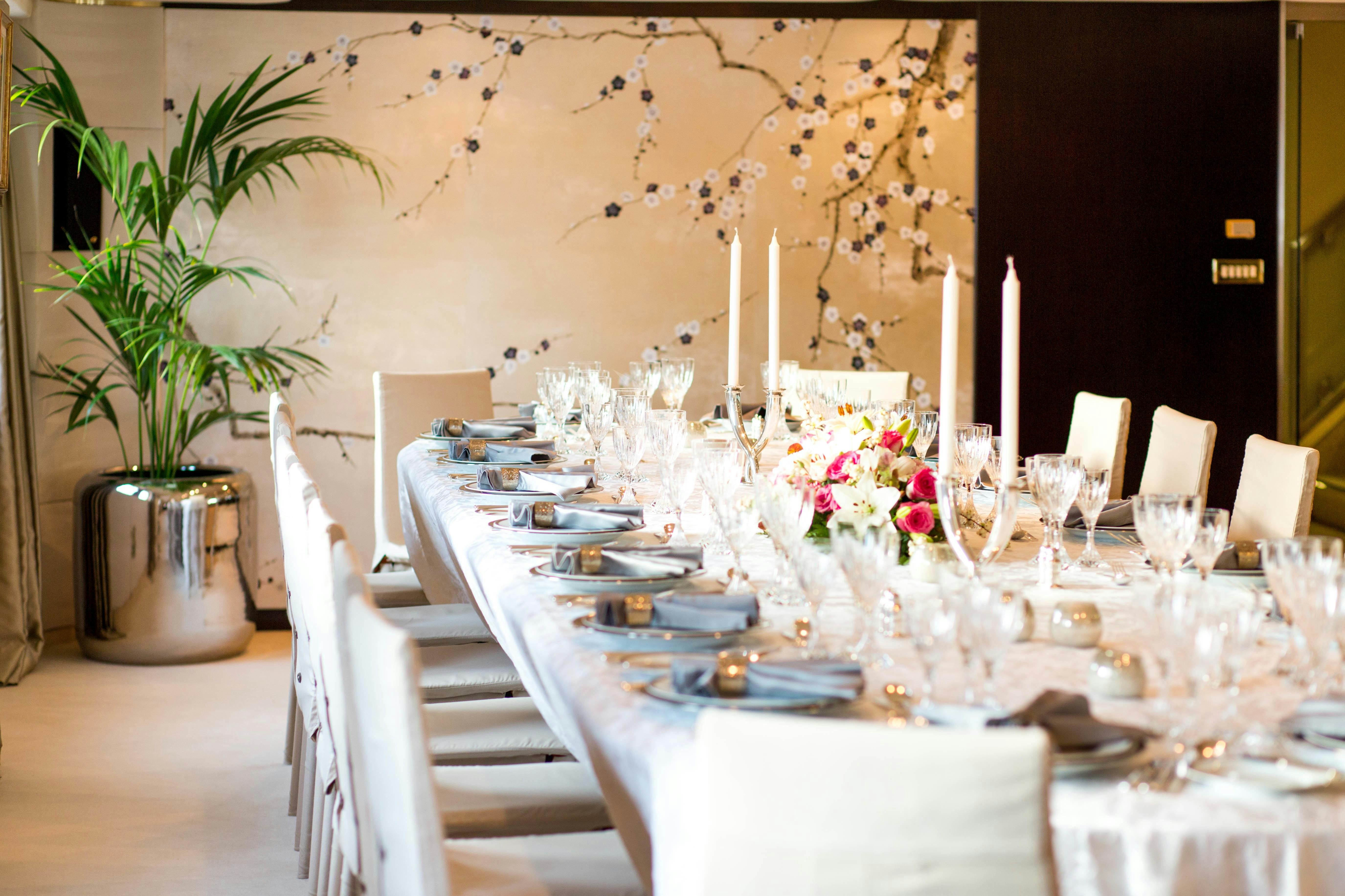 a table set with plates and glasses aboard ESMERALDA Yacht for Charter