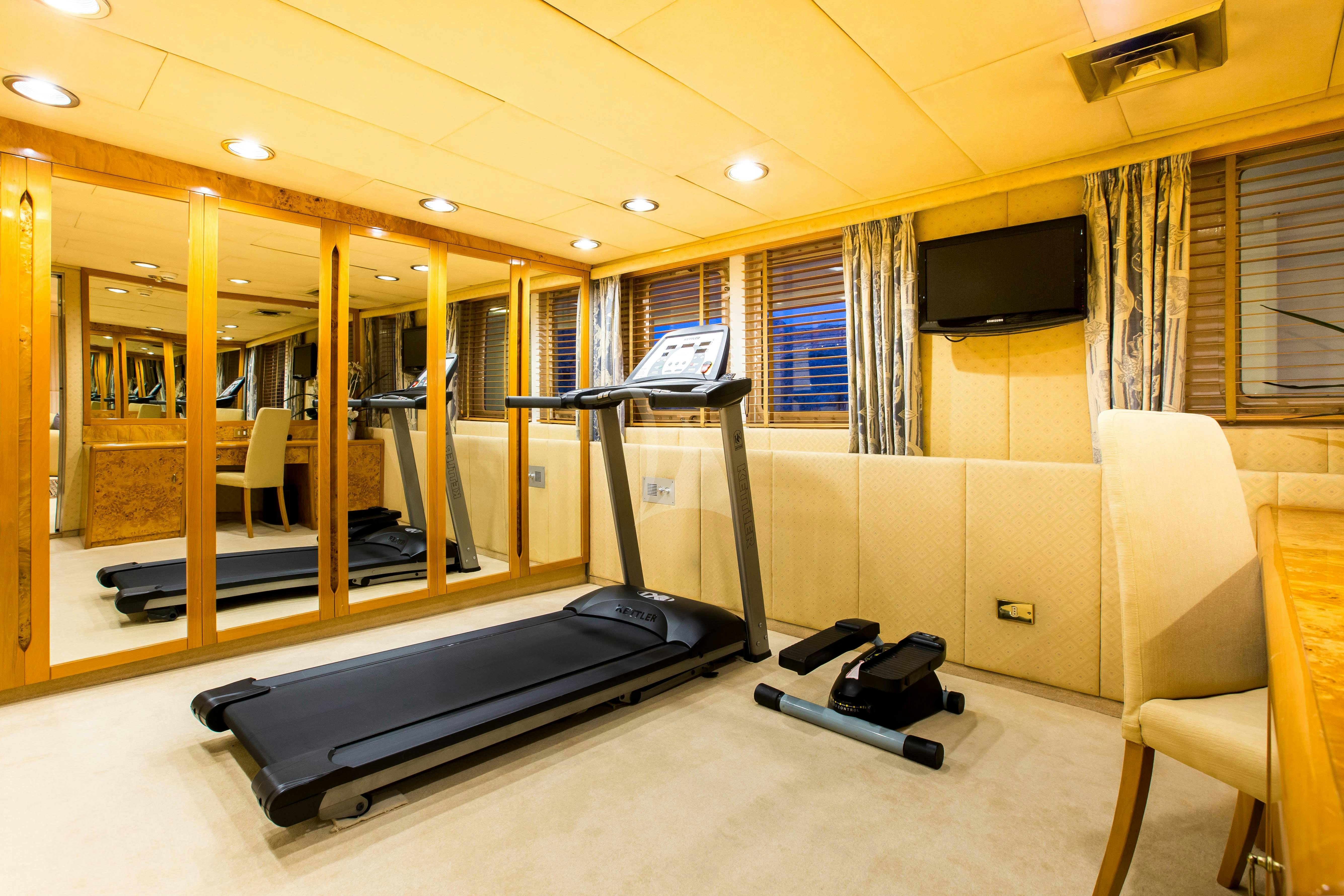 a room with a bed and a tv aboard ESMERALDA Yacht for Charter