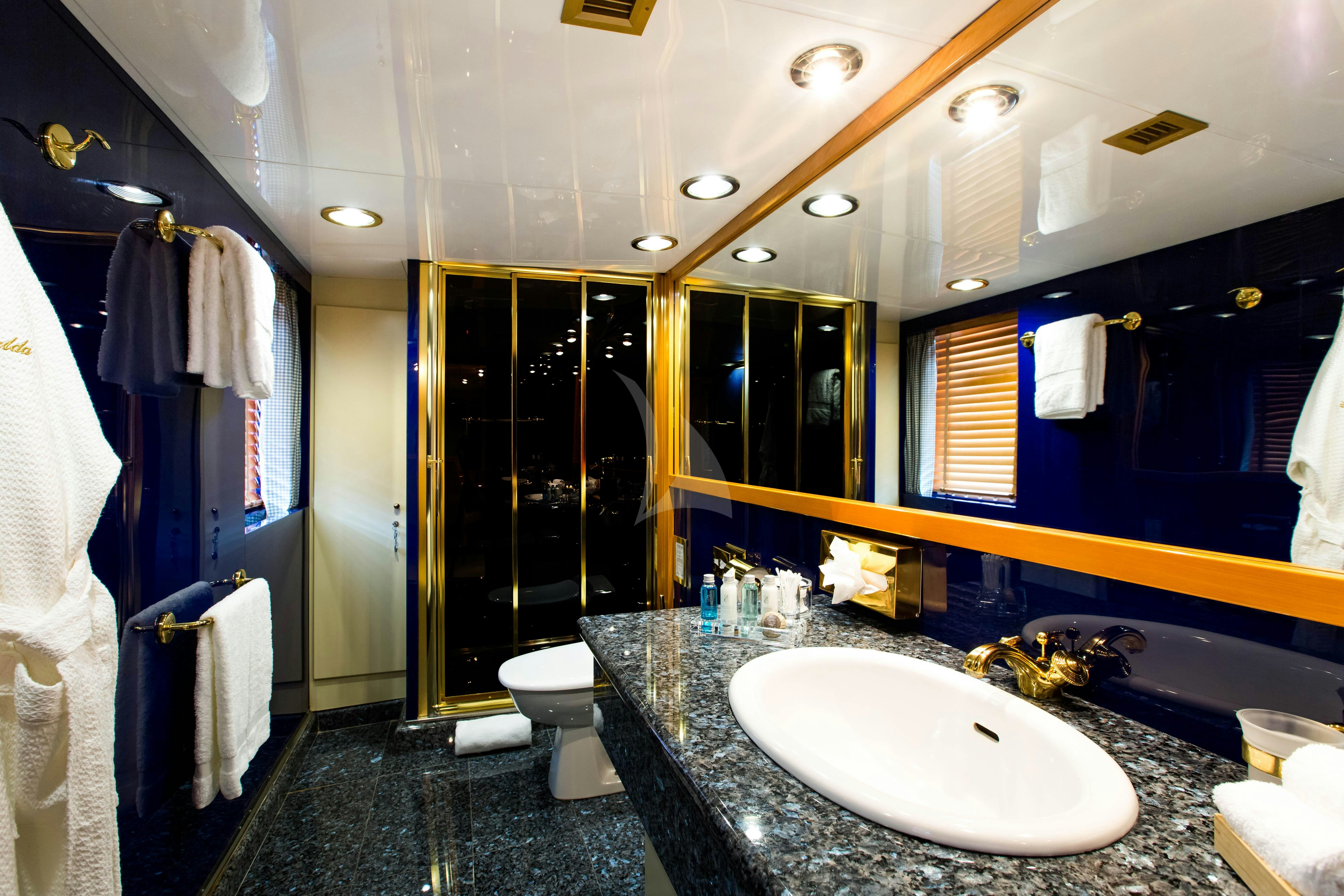 a bathroom with a large mirror aboard ESMERALDA Yacht for Charter